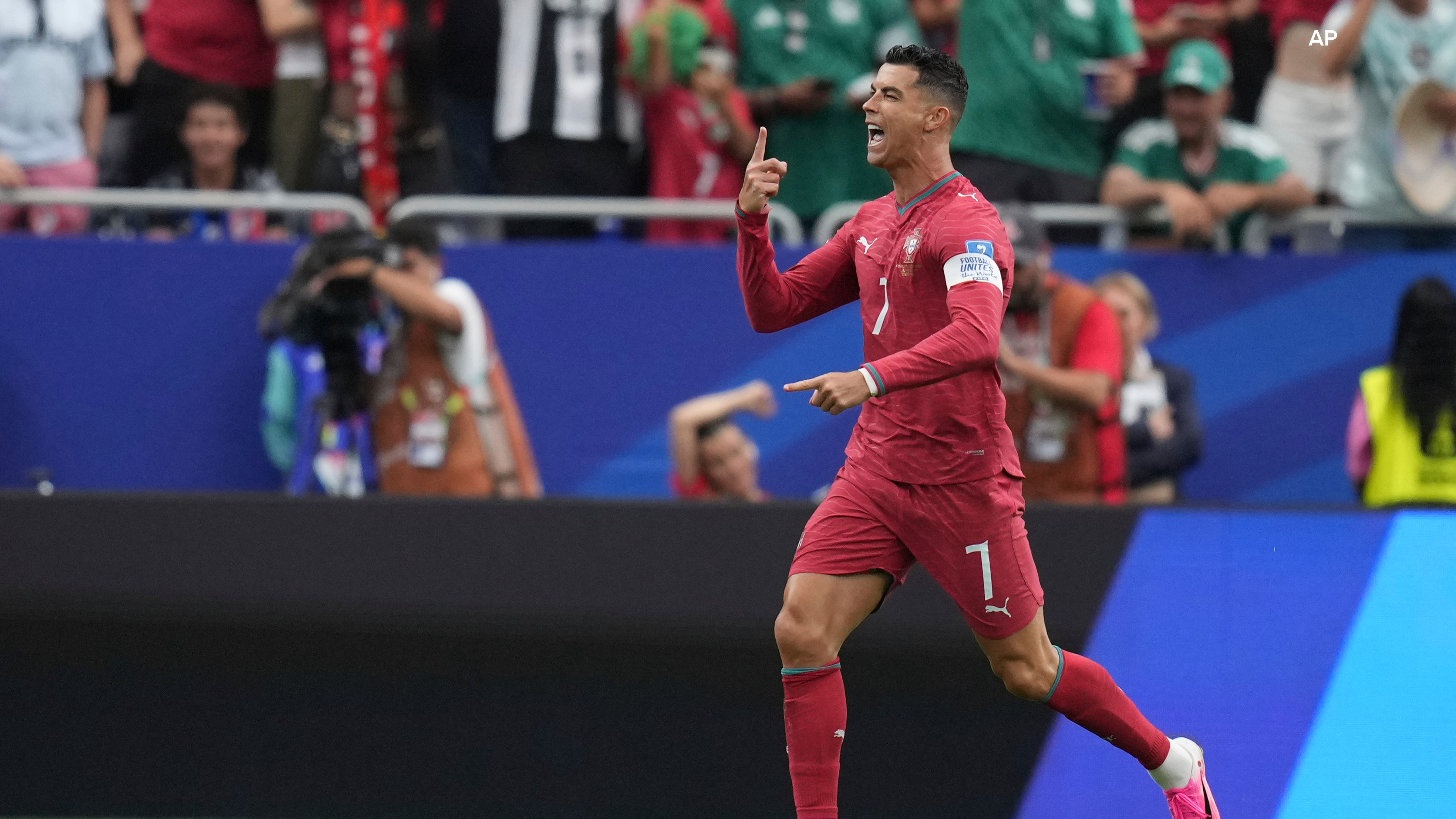 Cristiano Ronaldo celebrates after scoring the opening goal of his team during the World Cup Group K soccer match between Portugal and Uzbekistan in Houston. (AP Photo/Eric Gay)