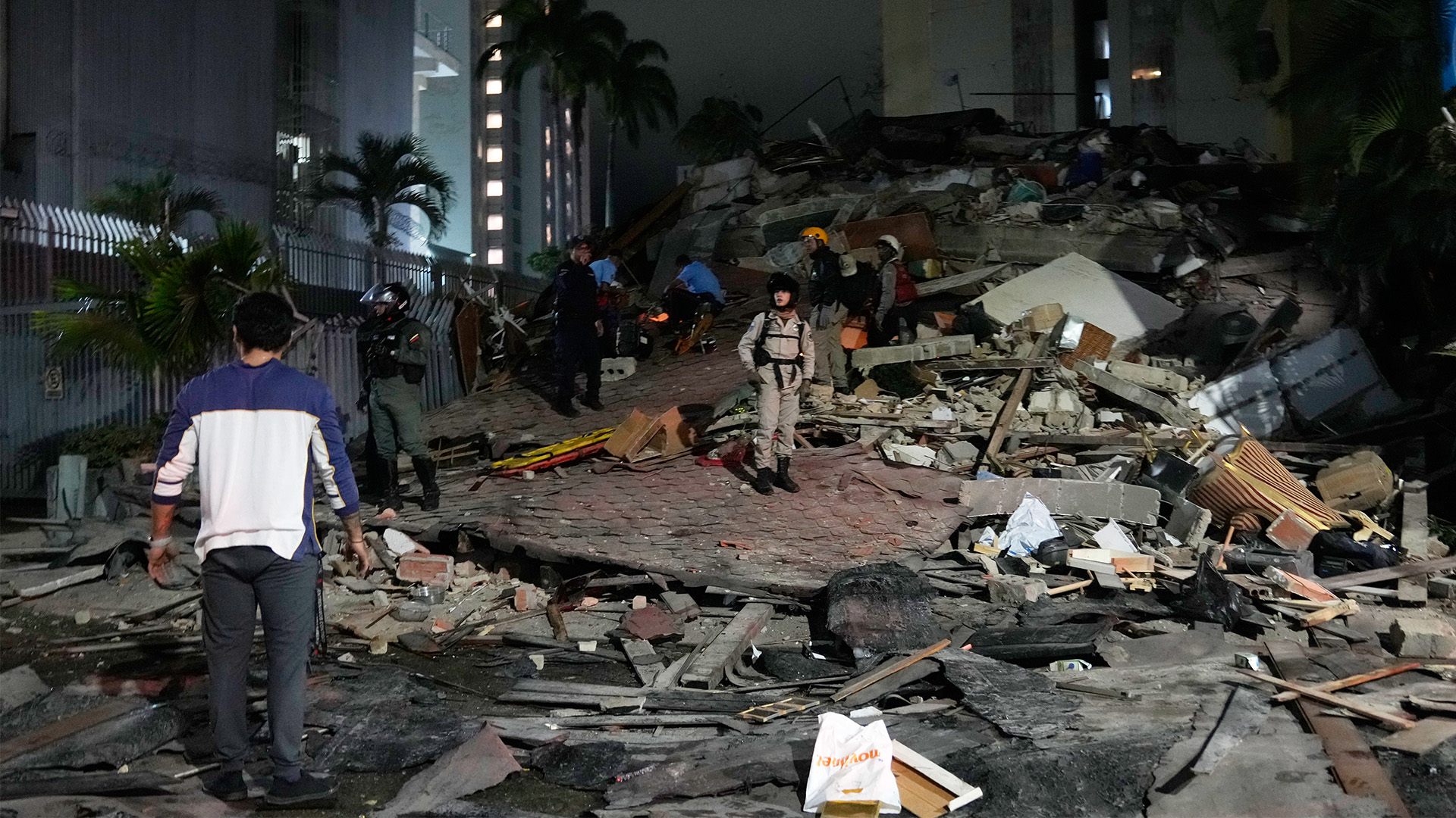 People walk amid debris after an earthquake in Caracas, Venezuela, Wednesday, June 24, 2026. 