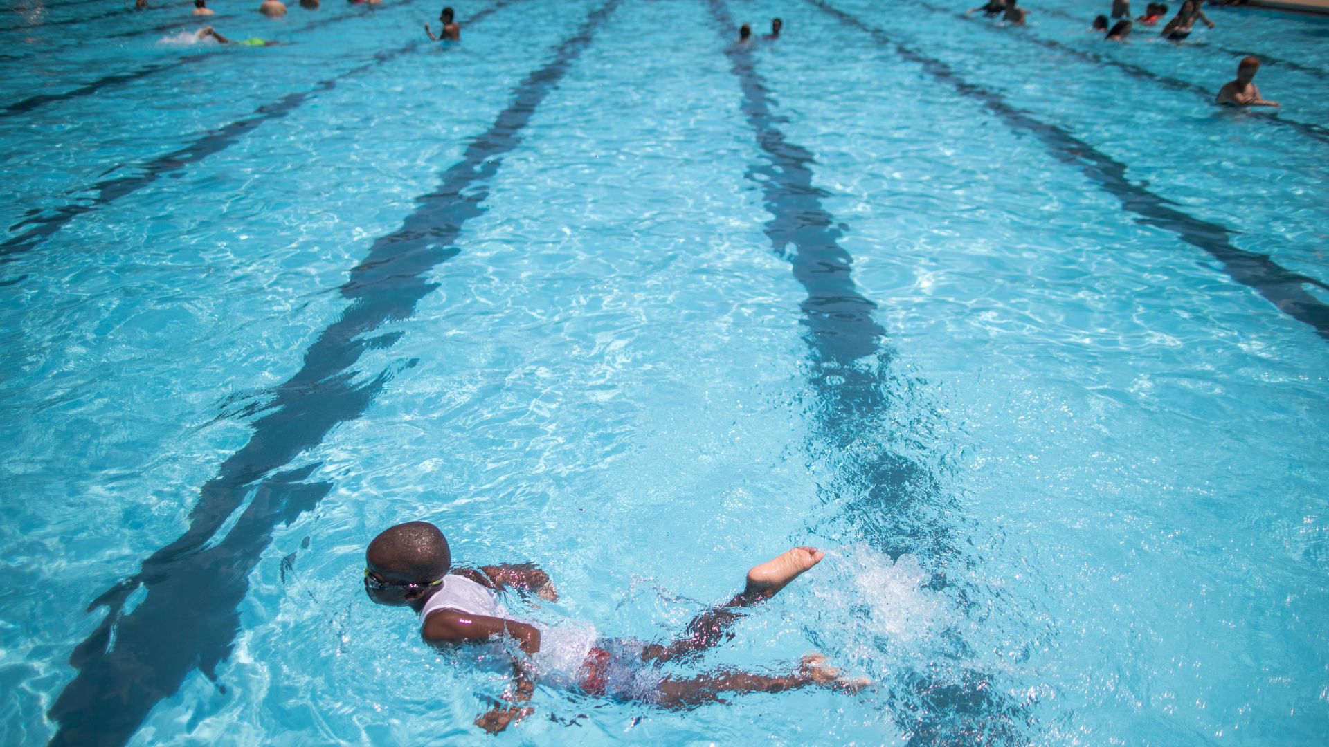 FILE - Children cool off at the Hamilton Fish pool, July 18, 2017, in the Lower East Side neighborhood of Manhattan.