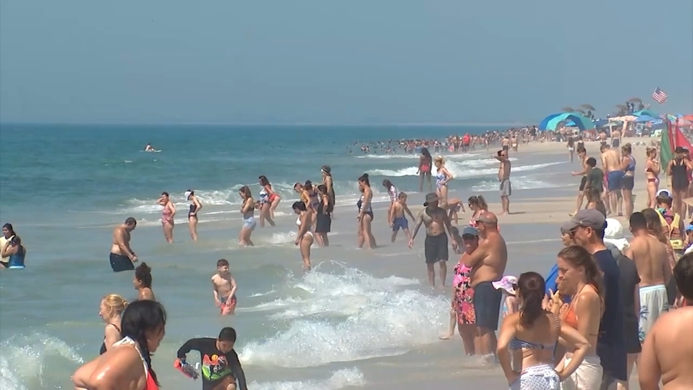 Beachgoers soak in the 4th of July holiday sun on Long Island