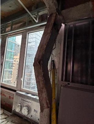 An image from inside the building shows a buckling column.
