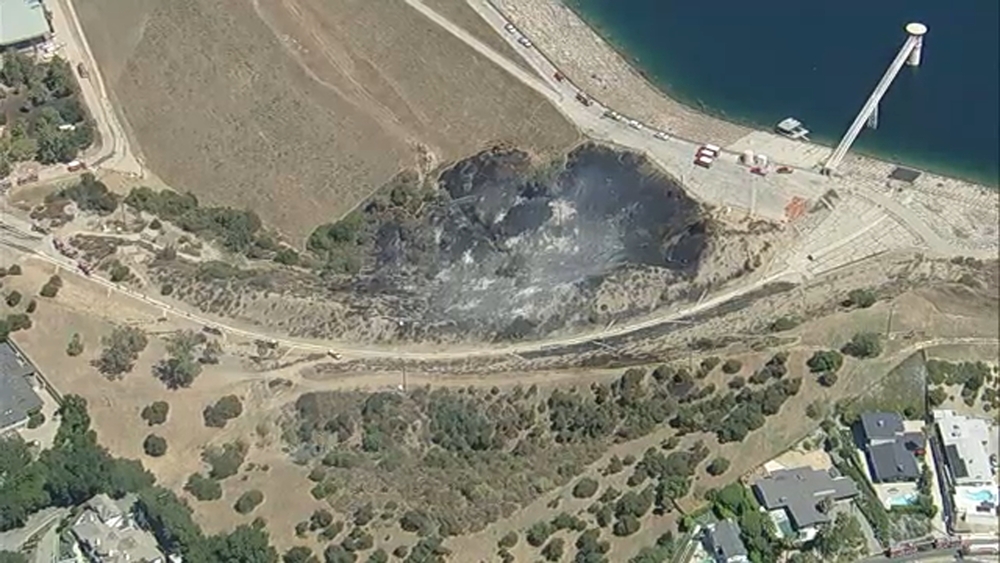 Water drops halt flames after brush fire erupts near Encino Reservoir