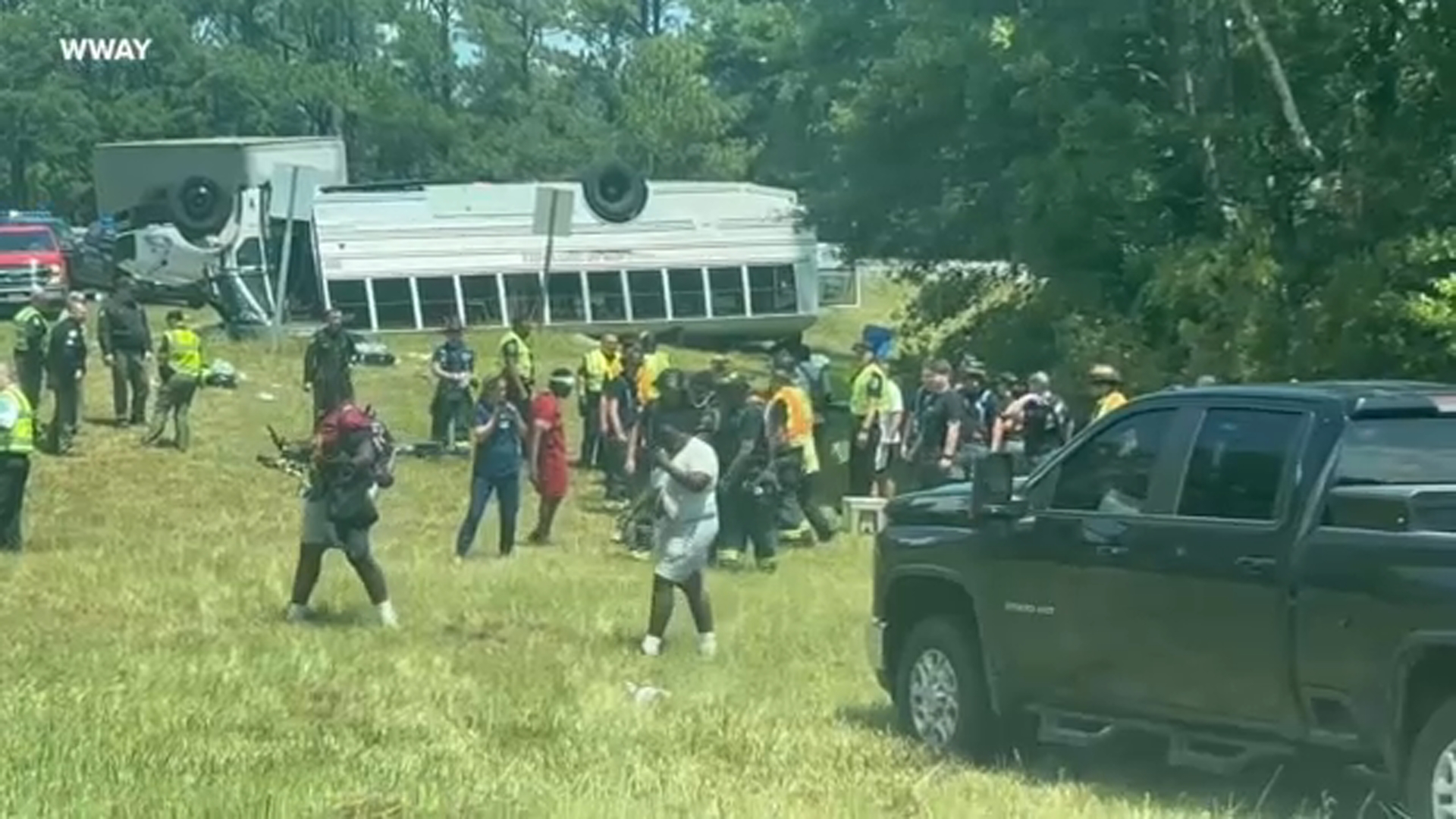 Students mill around at the scene after the bus overturned.