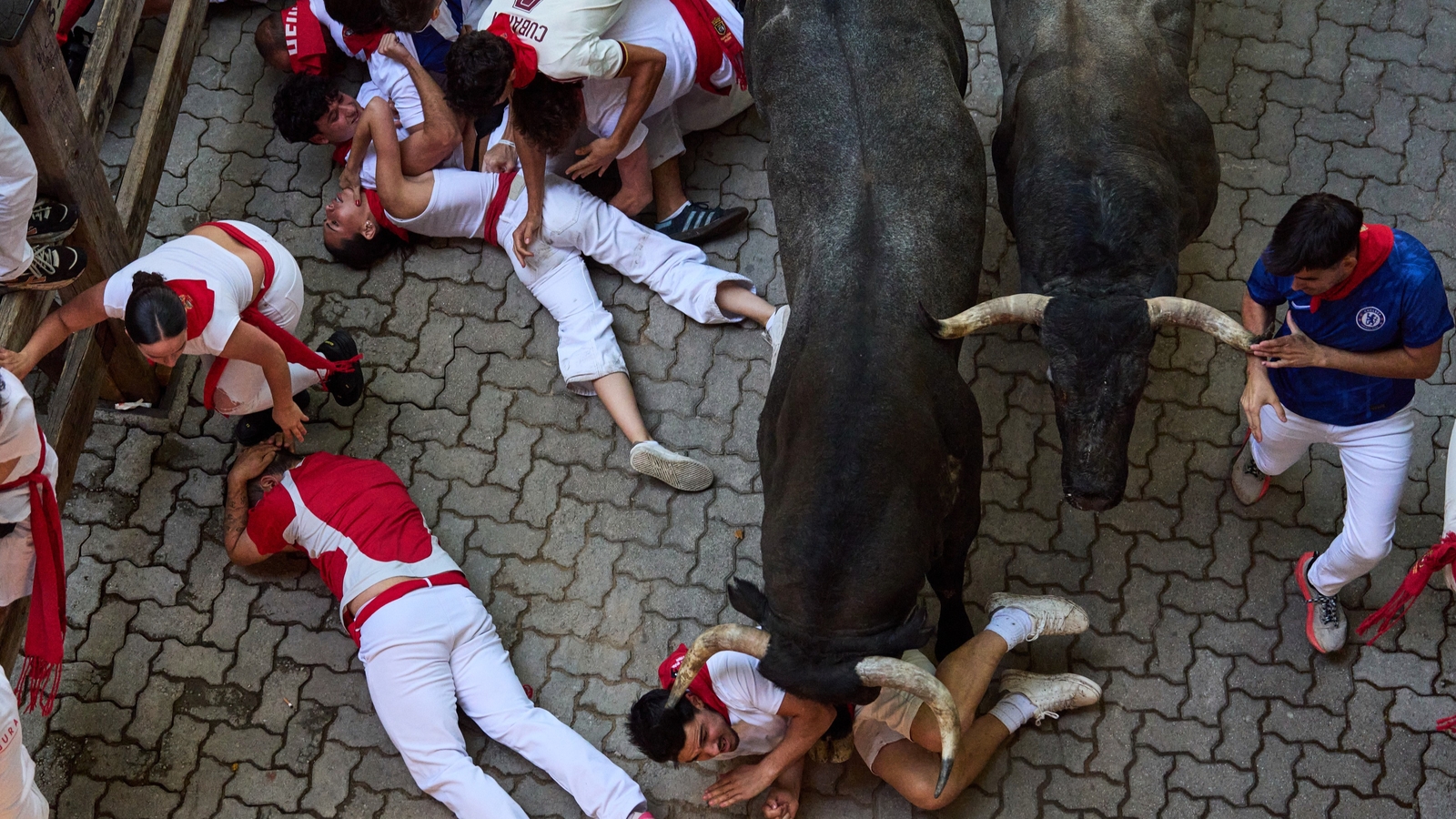 One runner has been gored in the face, and many more were fortunate to not be seriously injured during a chaotic bull run at Spain's San Fermin festival on Saturday.