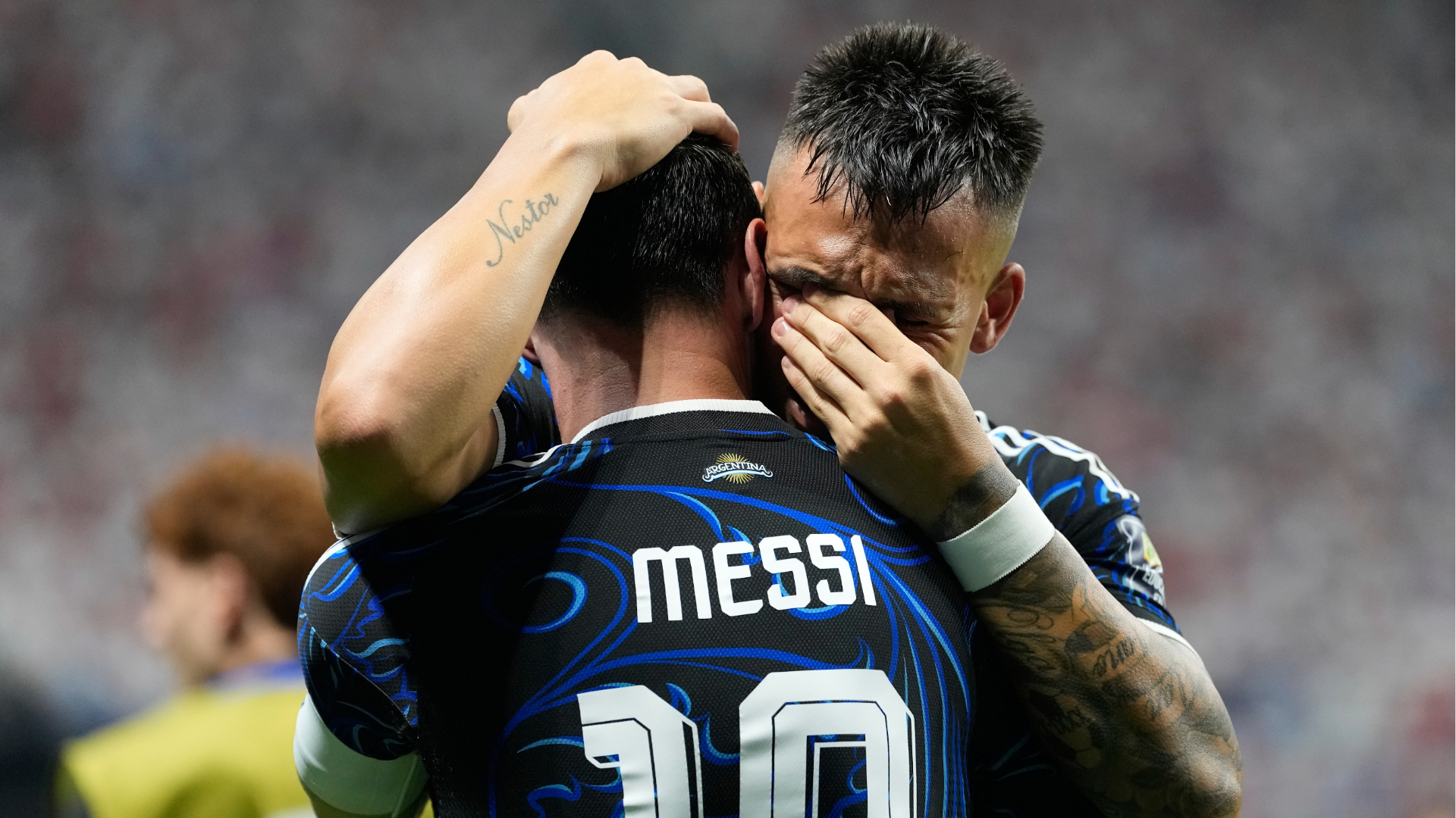 Argentina's Lautaro Martinez hugs teammate Lionel Messi celebrating after scoring their side's second goal during the World Cup semifinal soccer match between England and Argentina in Atlanta, Wednesday, July 15, 2026.