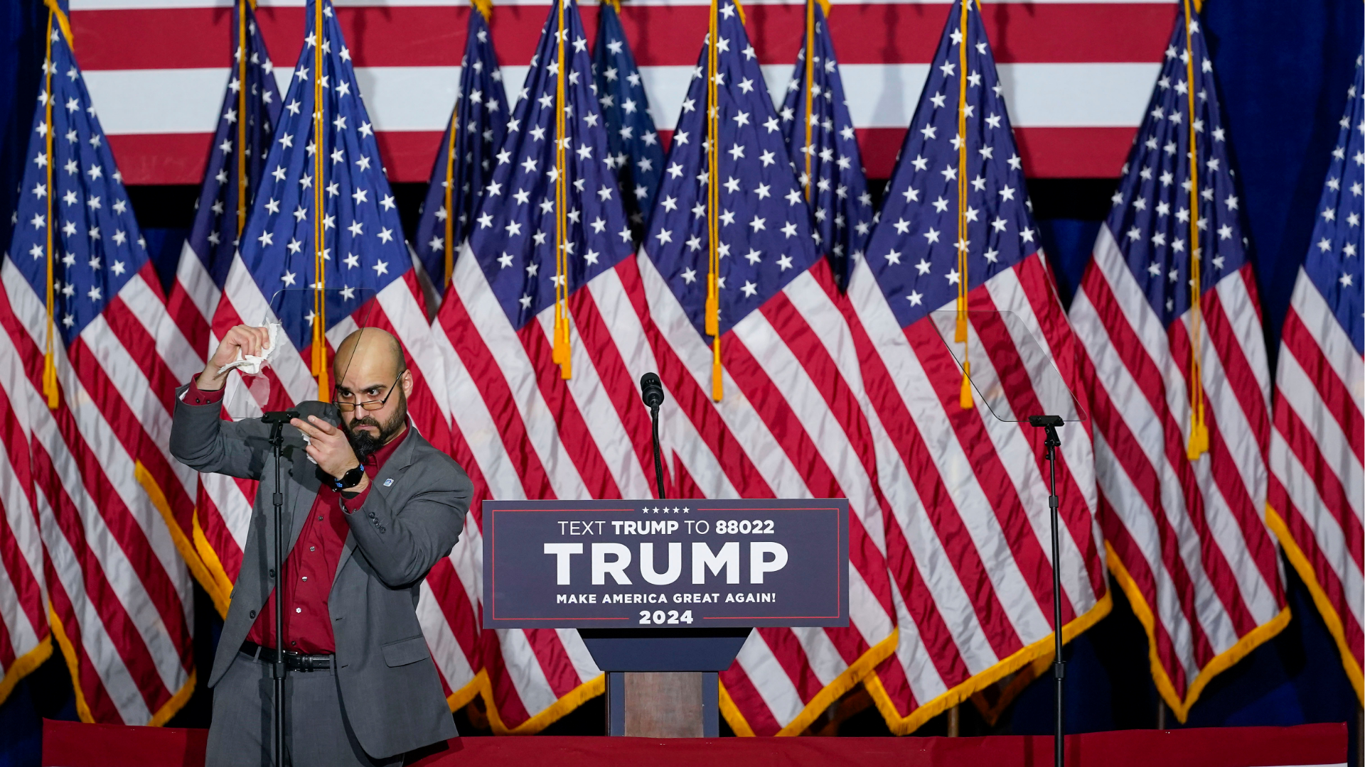 FILE - A member of the campaign on stage making the final adjustments on the teleprompter before the appearance of Republican presidential candidate former President Donald Trump at a caucus night party in Des Moines, Iowa, Monday, Jan. 15, 2024.