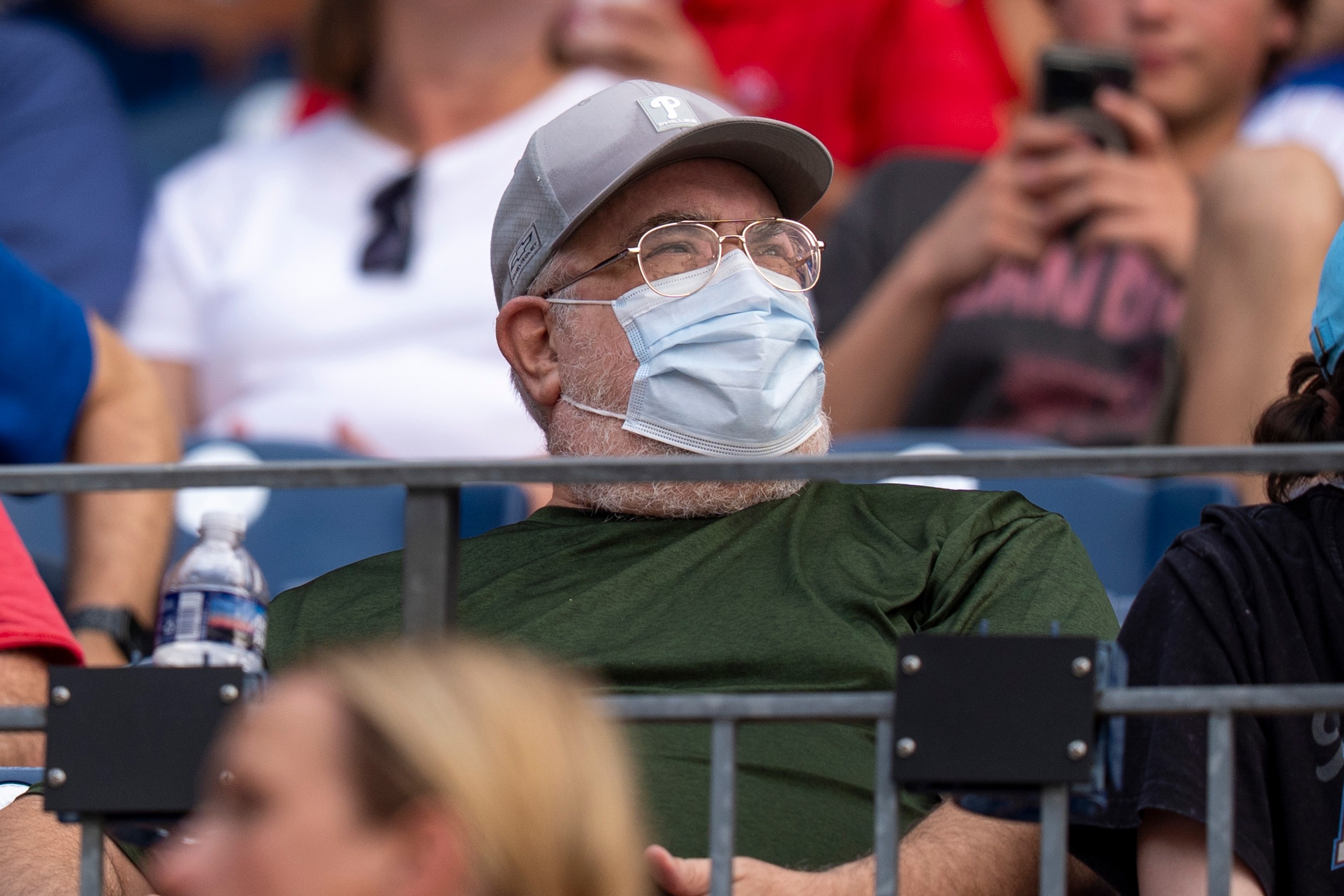 A fan wears a mask during an air quality warning from wildfire smoke prior to baseball game between the New York Mets and the Phillies, July 16, 2026, in Philadelphia.