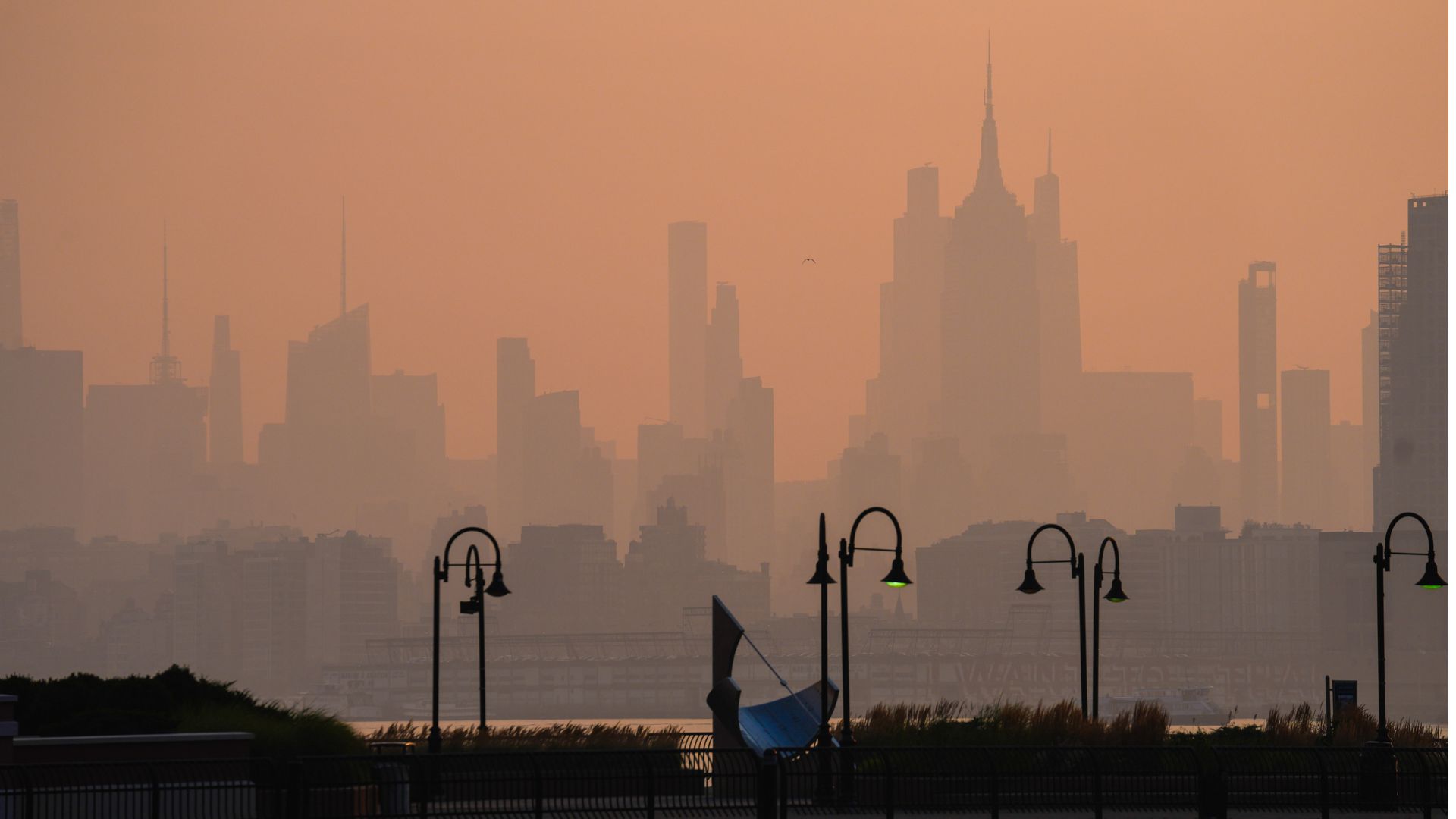 The New York City skyline is seen through a cover of wildfire smoke, in Jersey City, N.J., Friday, July 17, 2026.