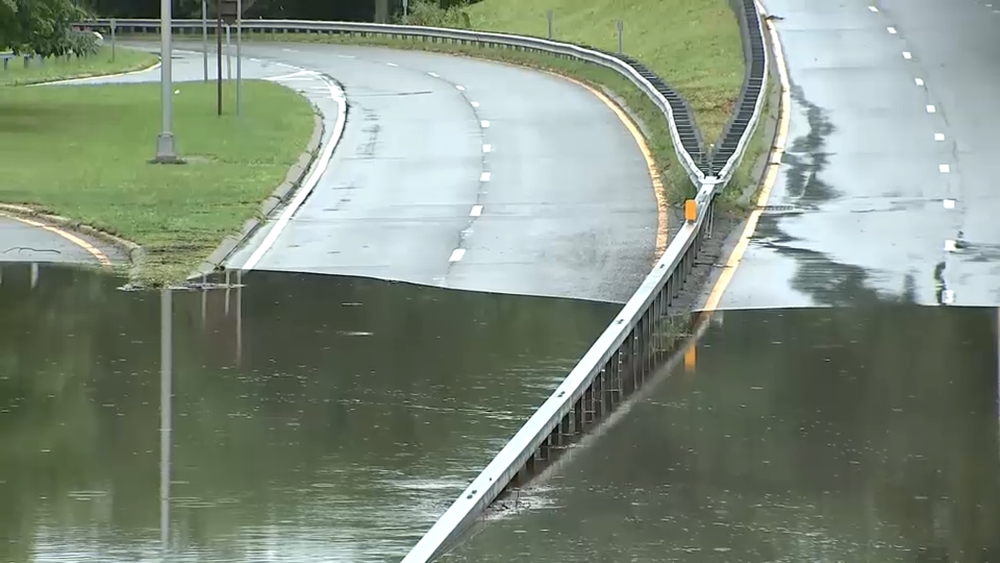 Flooding swallows car in Bronx River Parkway