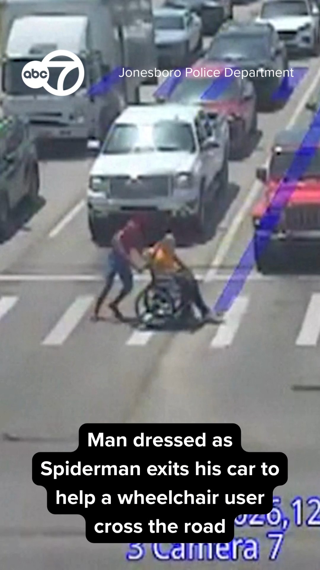 Man dressed as Spider-Man helps wheelchair user cross street