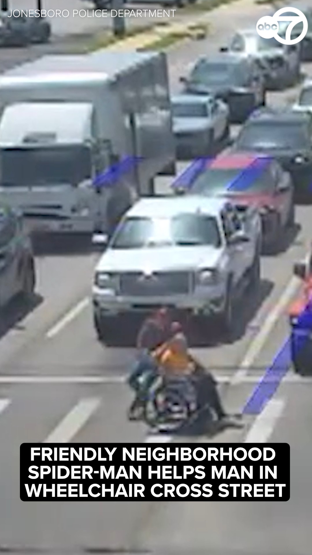 Friendly neighborhood Spider-Man helps man in wheelchair cross street
