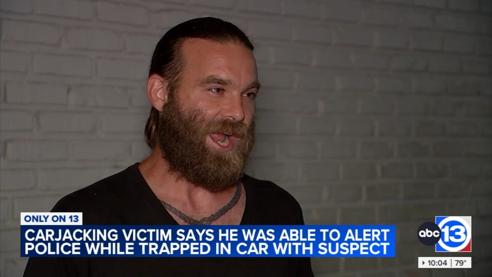 Carjacking victim says he was able to alert police while trapped in car with suspect