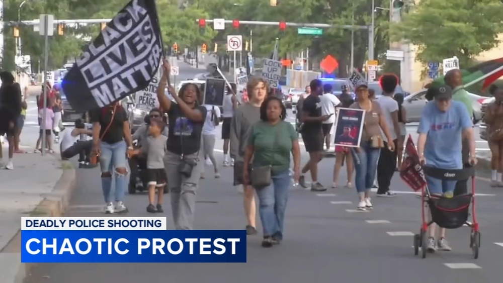 Protesters march in Wilmington one month after fatal police shooting