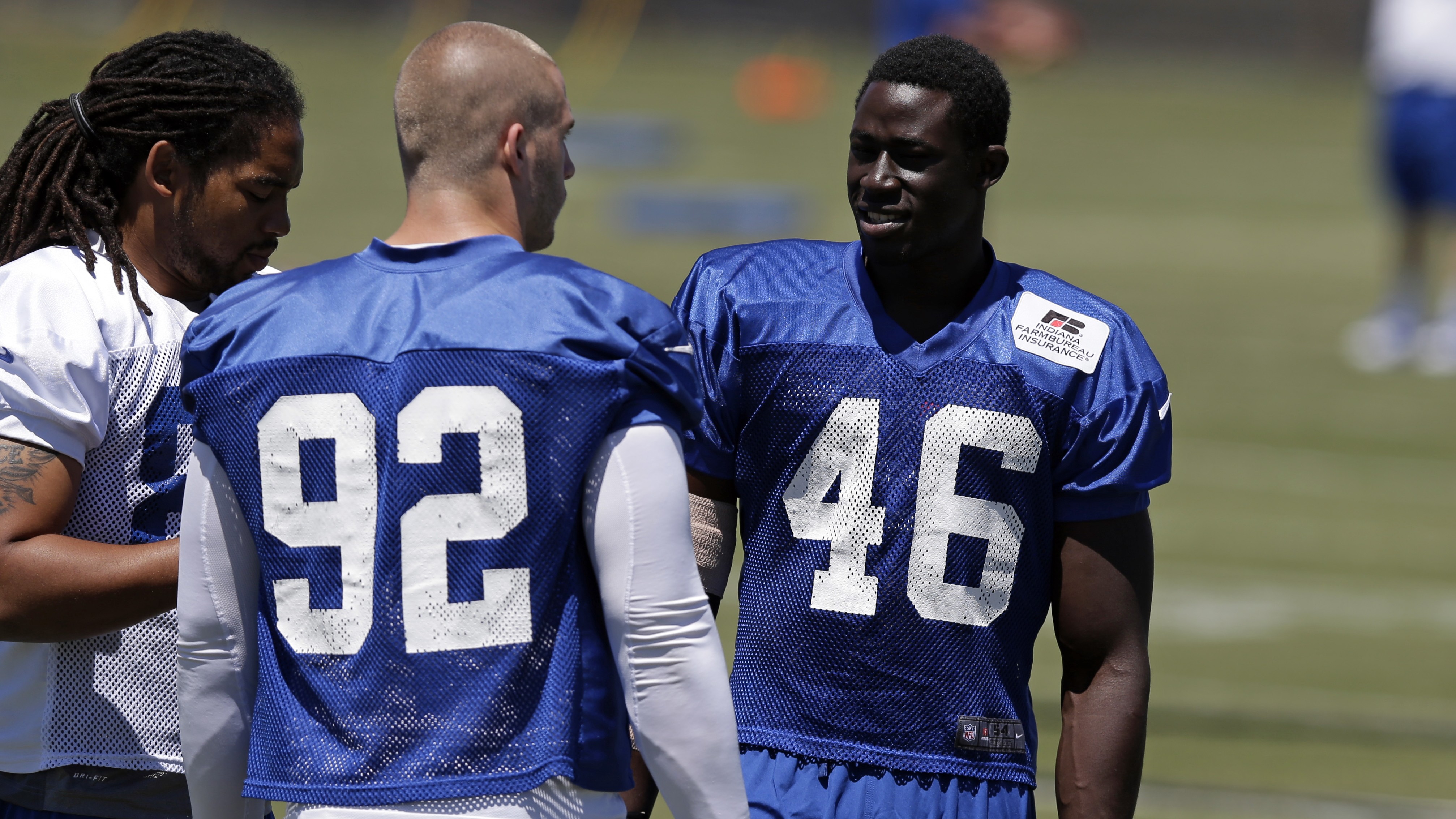 Indianapolis Colts linebacker Daniel Adongo, right, of Kenya, talks with linebacker Bjoern Werner (92) and tight end Justice Cunningham
