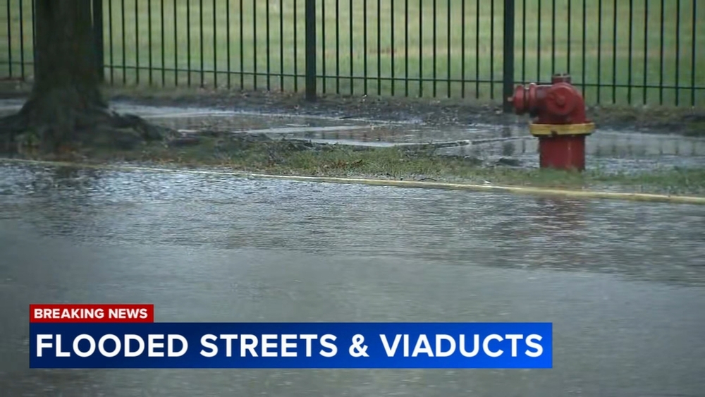 Cars stuck after driving through flooded streets in Little Village