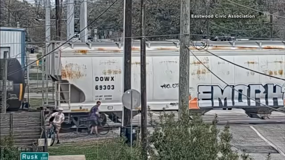 Cameras capture someone crossing a slow-moving train in east Houston