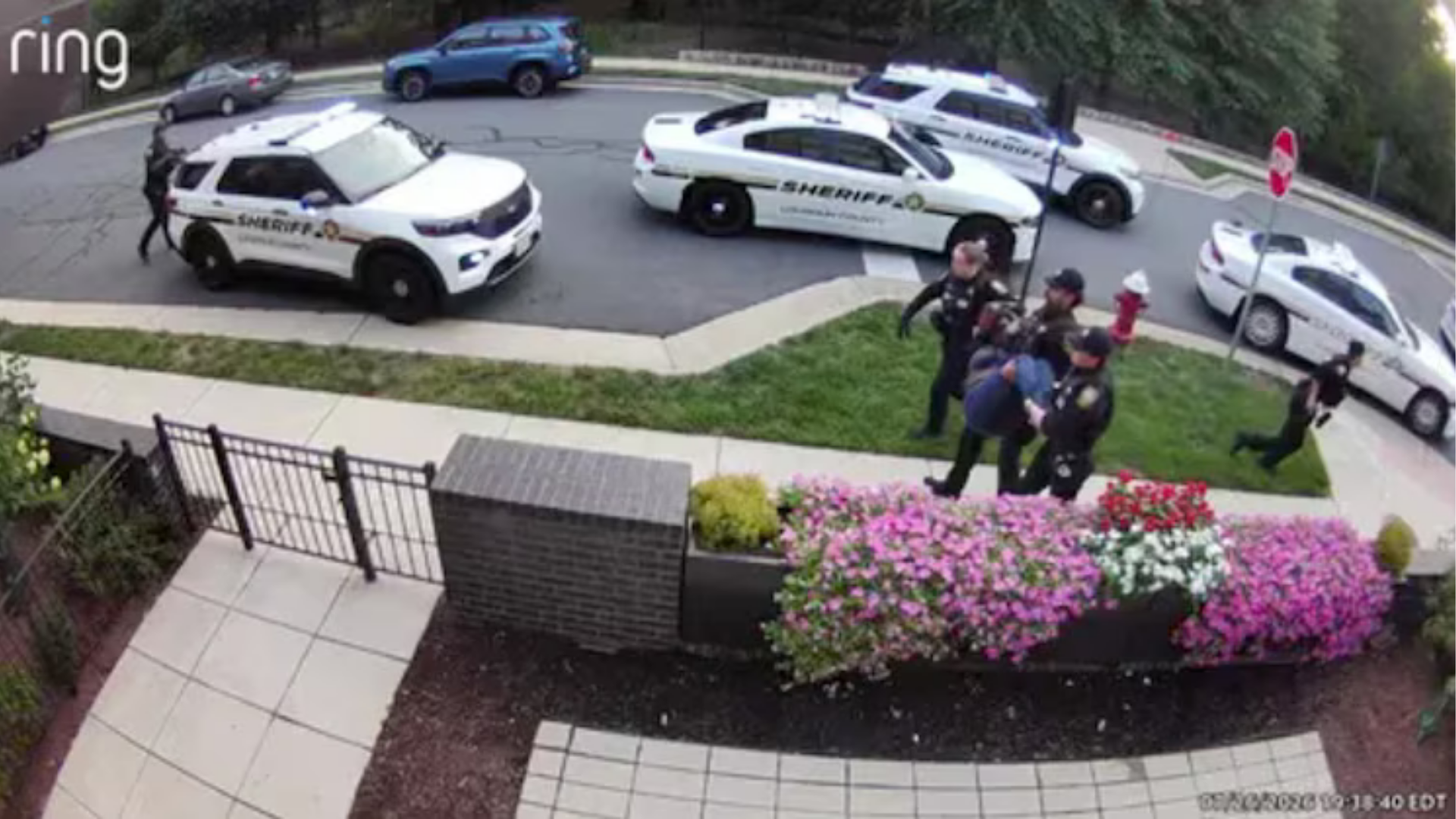 Mia Bieniemy is escorted from her home following a shooting incident, July 26, 2026, in Loudoun County, Virginia.