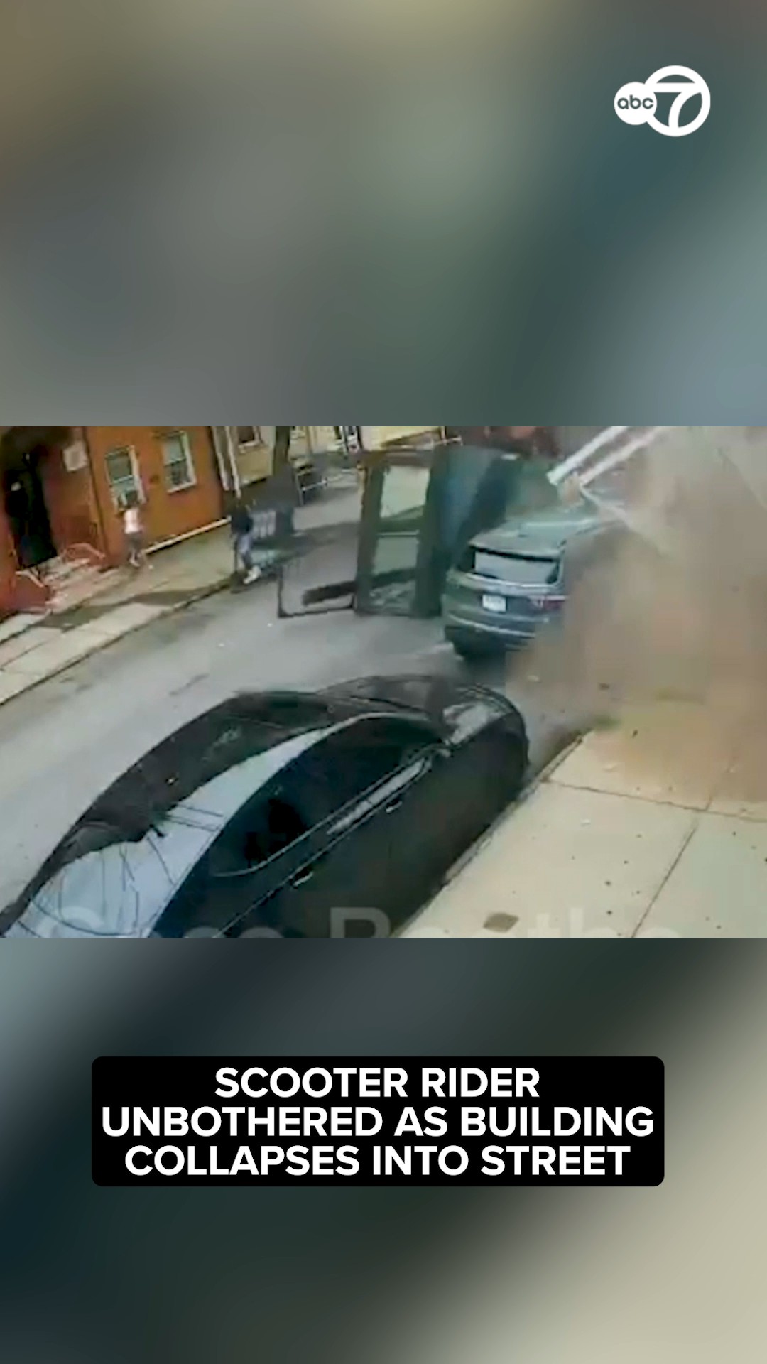 Scooter rider unbothered as building collapses into street