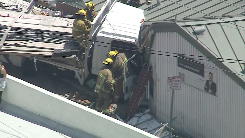 Driver rescued after truck slams into building in Pacific Palisades
