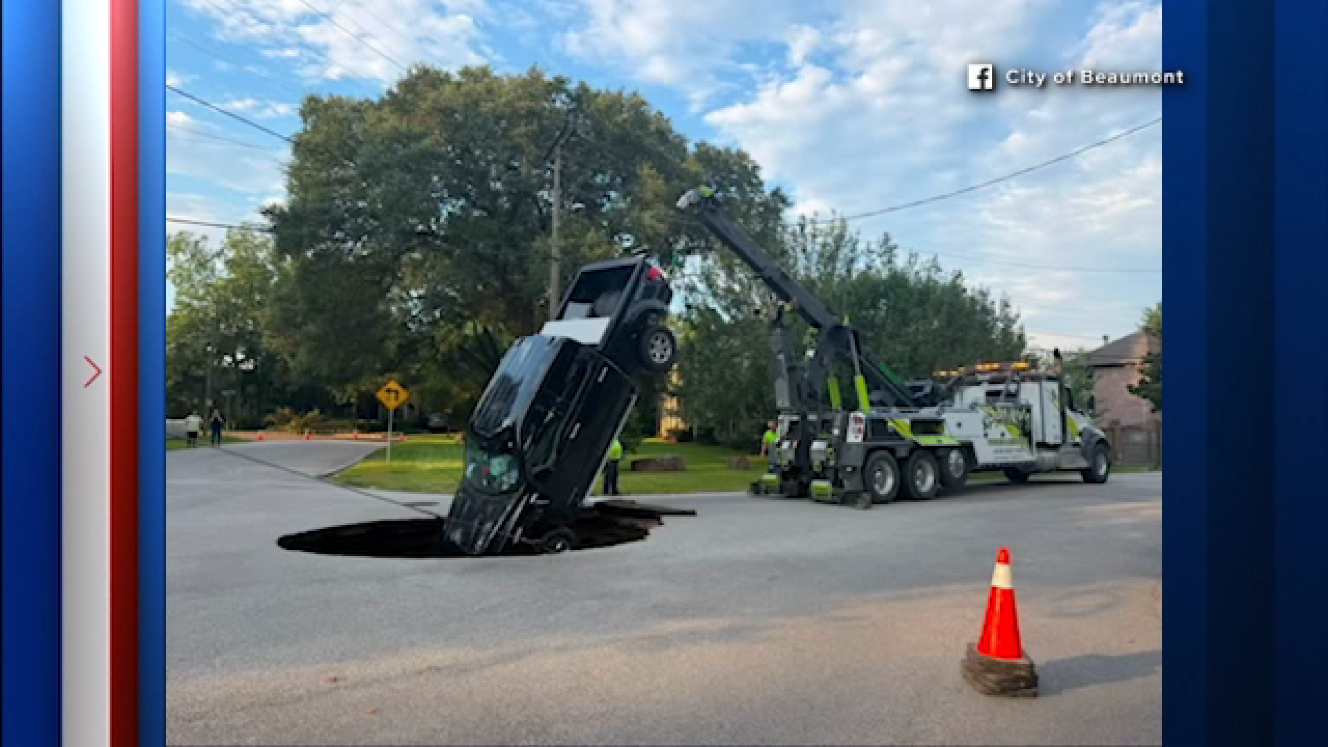 An image shared by the City of Beaumont shows a truck being removed from a hole officials said was caused by a water main break on Sunday morning.