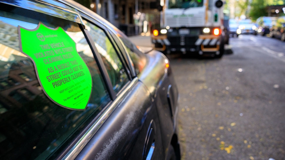 NYC shames parking-rule violators with big green stickers pasted onto cars