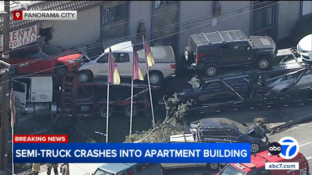 Car hauler crashes into Panorama City apartment building