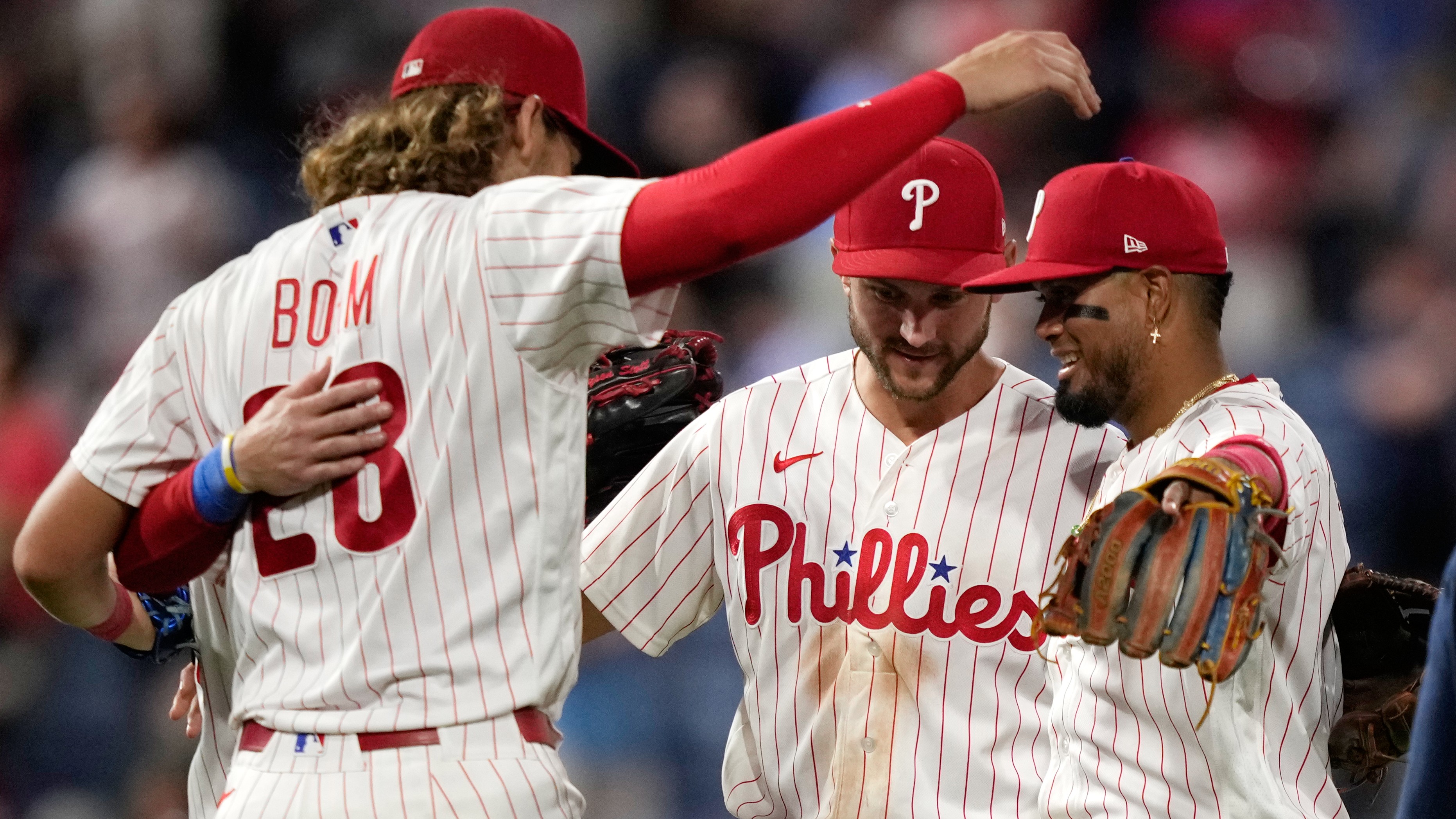 Philadelphia Phillies' Luis Arraez, Trea Turner and Alec Bohm celebrate after the Phillies win against the Washington Nationals Tuesday, Aug. 4, 2026, in Philadelphia.