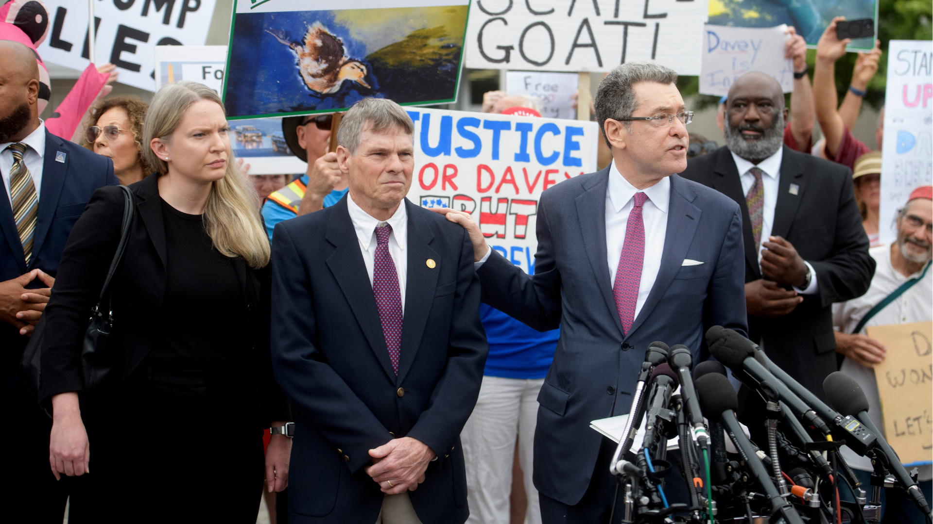 Former Olympic canoeist David Hearn, second from left, listens as his attorney Norman Eisen, right, speaks after he pleaded not guilty to allegedly damaging the Lincoln Memorial Reflecting Pool, Thursday, July 9, 2026, in Washington. 