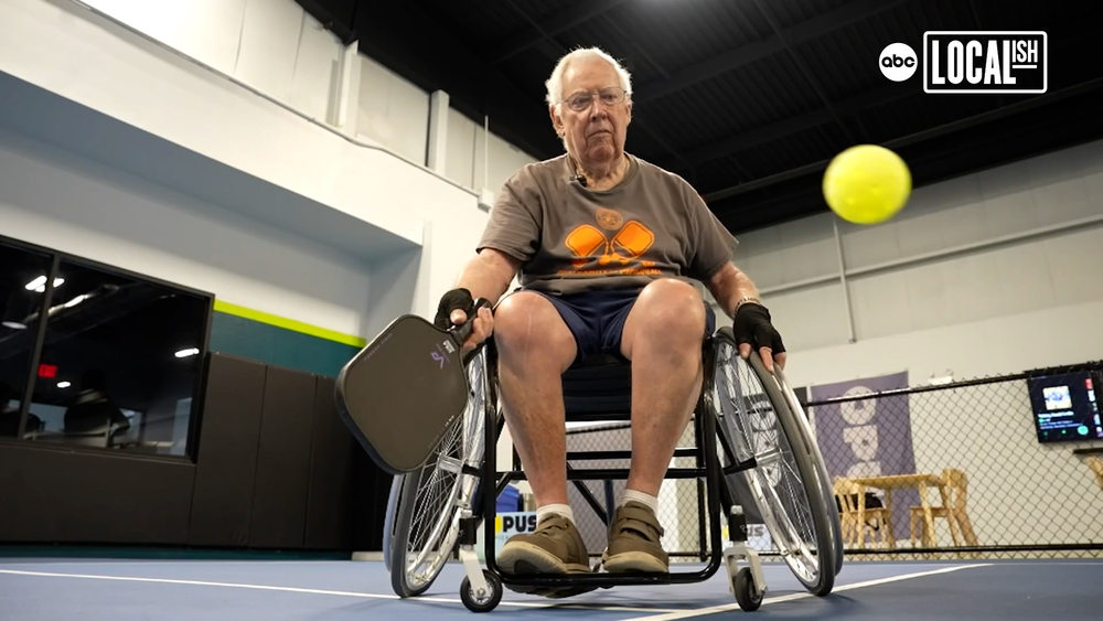 Wheelchair pickleball player swings his paddle with a purpose