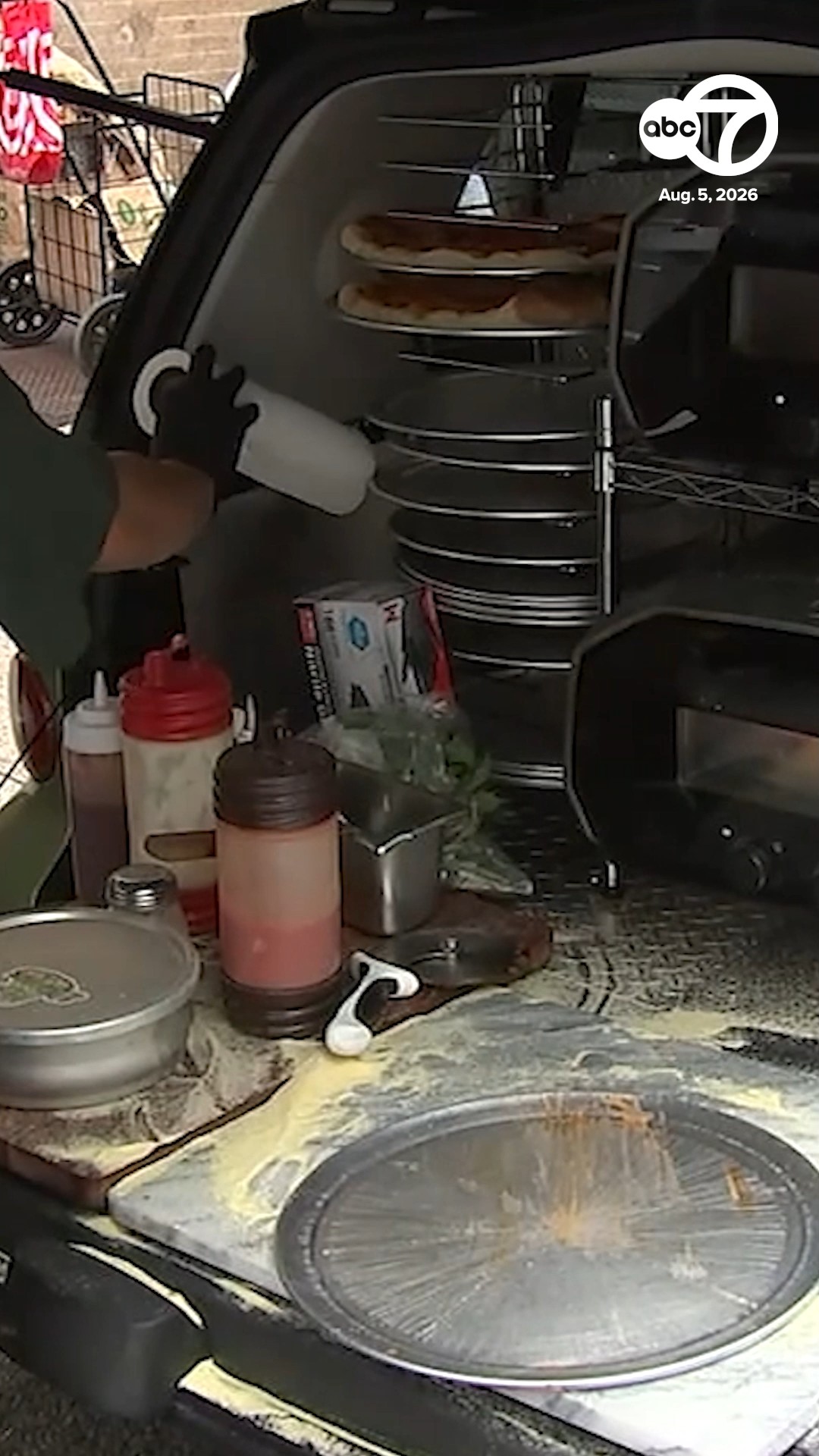 Crowds flock to get pizza out of the trunk of a smart car