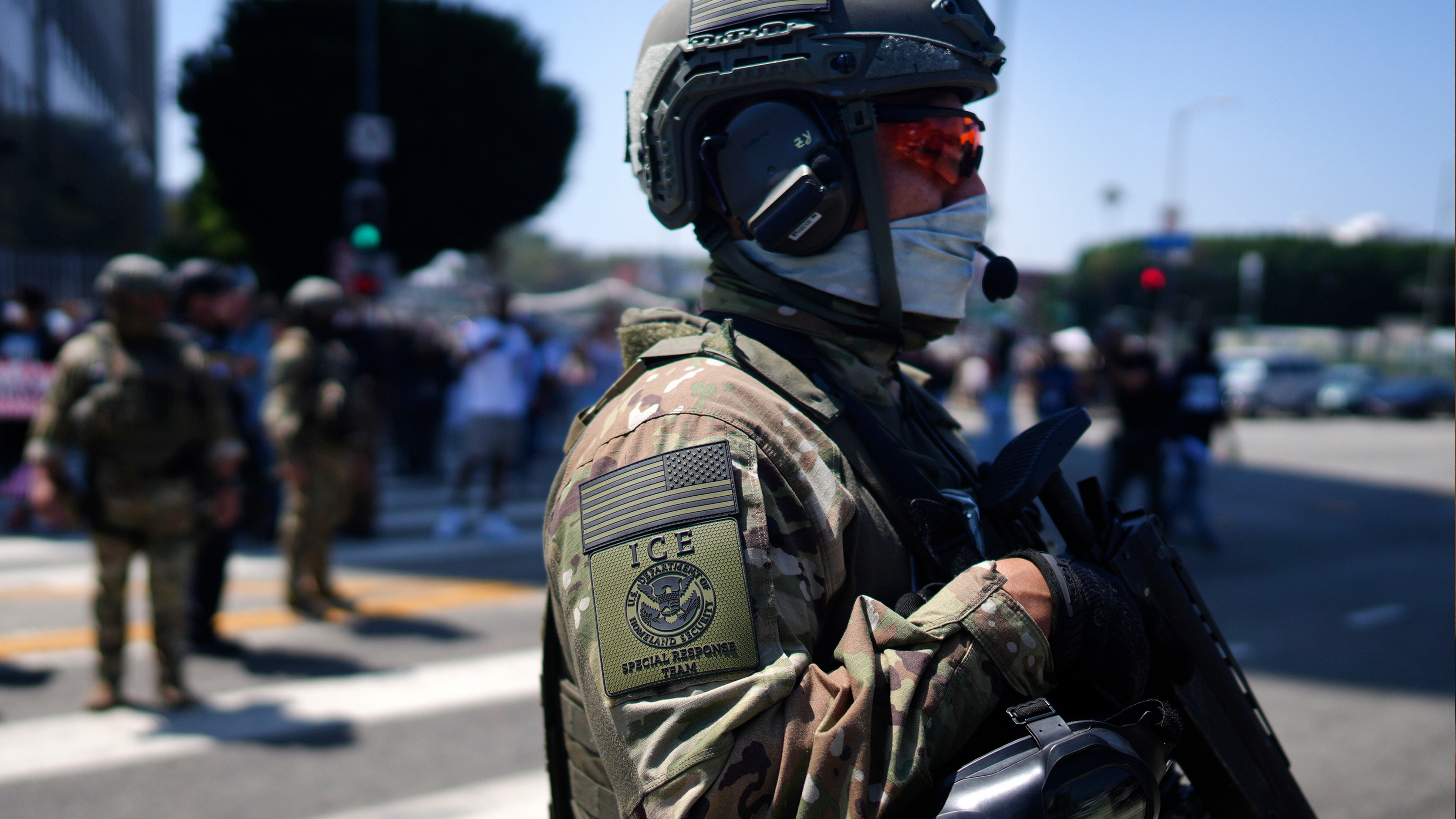 An ICE Special Response Team member stands guard outside the Metropolitan Detention Center, while protesters gather outside to denounce the ICE, U.S. Immigration and Customs Enforcement, operations, June 10, 2025, in downtown Los Angeles.