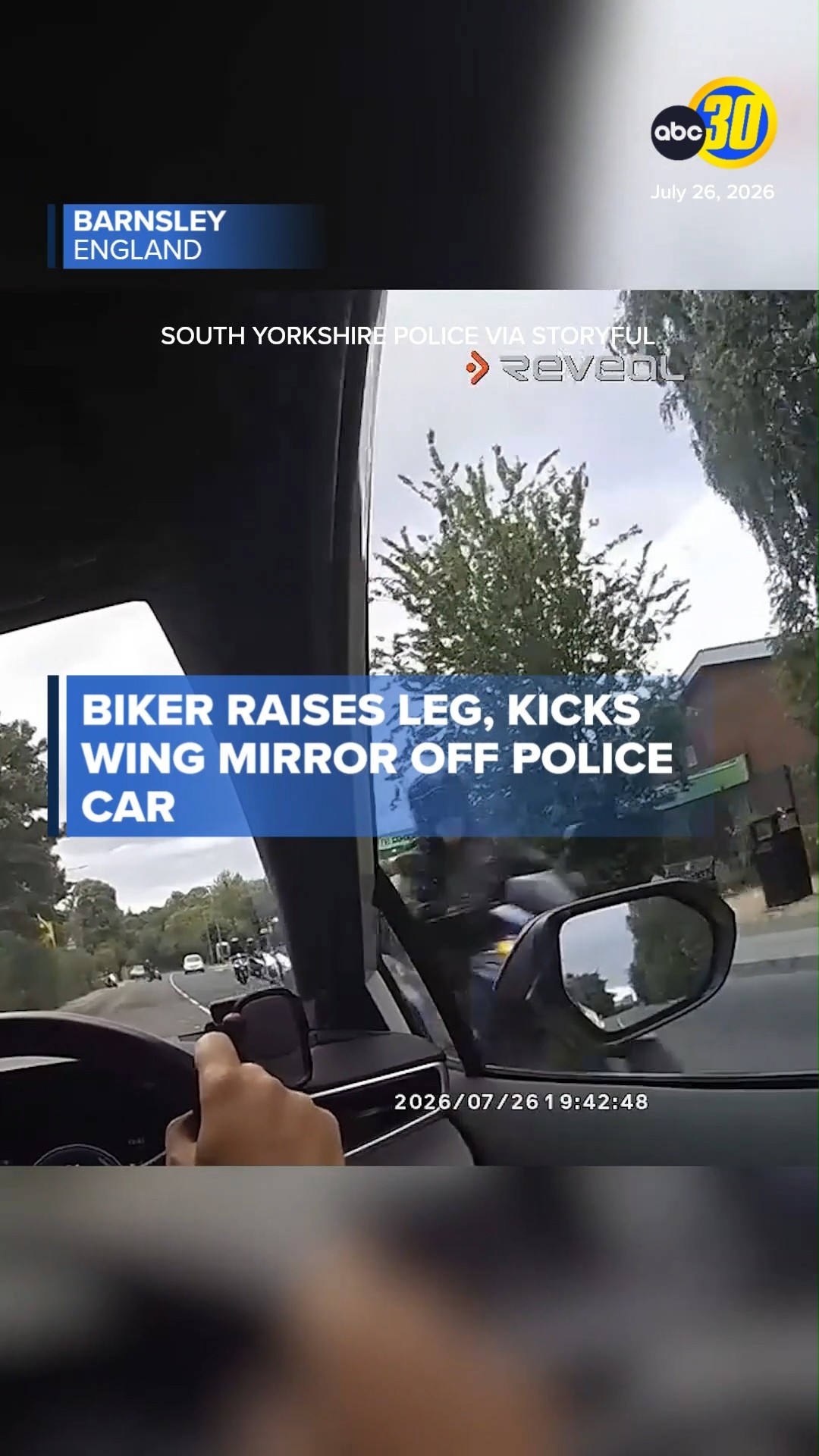 Biker raises leg, kicks wing mirror off police car