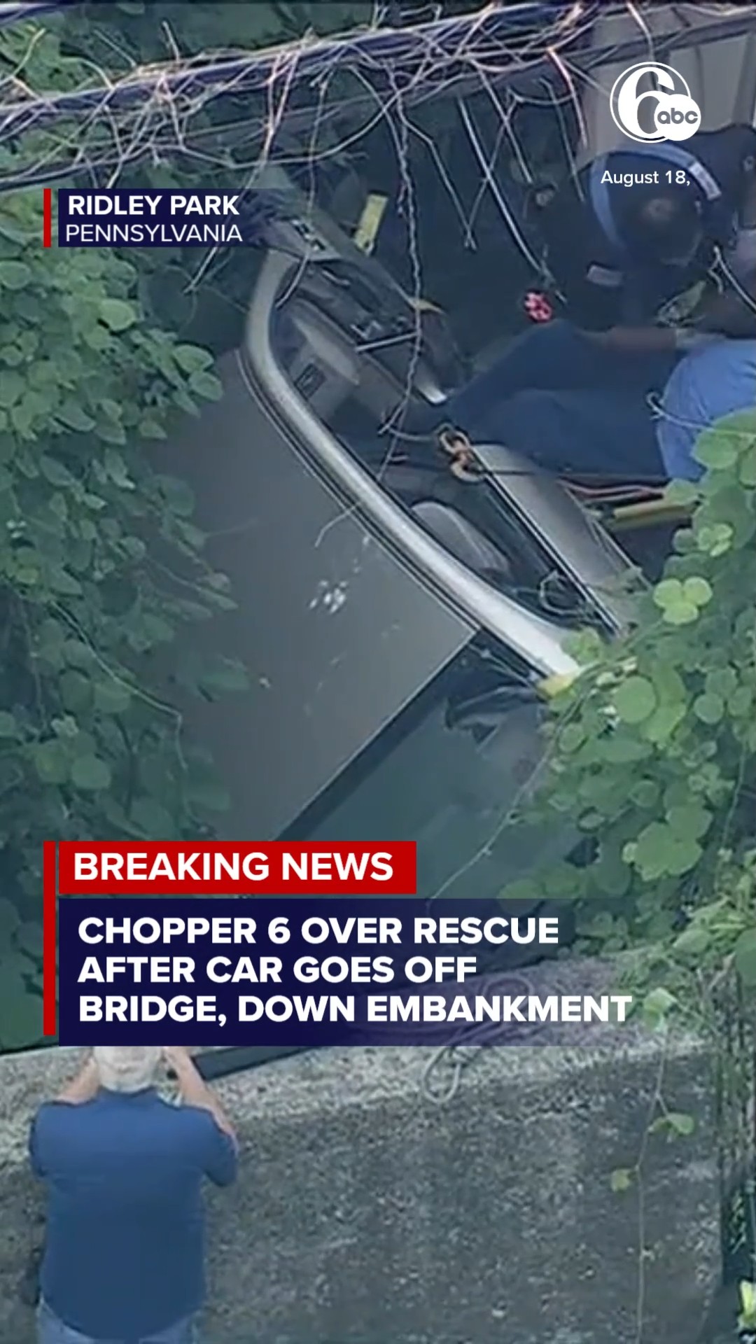 Person pulled from car after vehicle goes off bridge, down embankment
