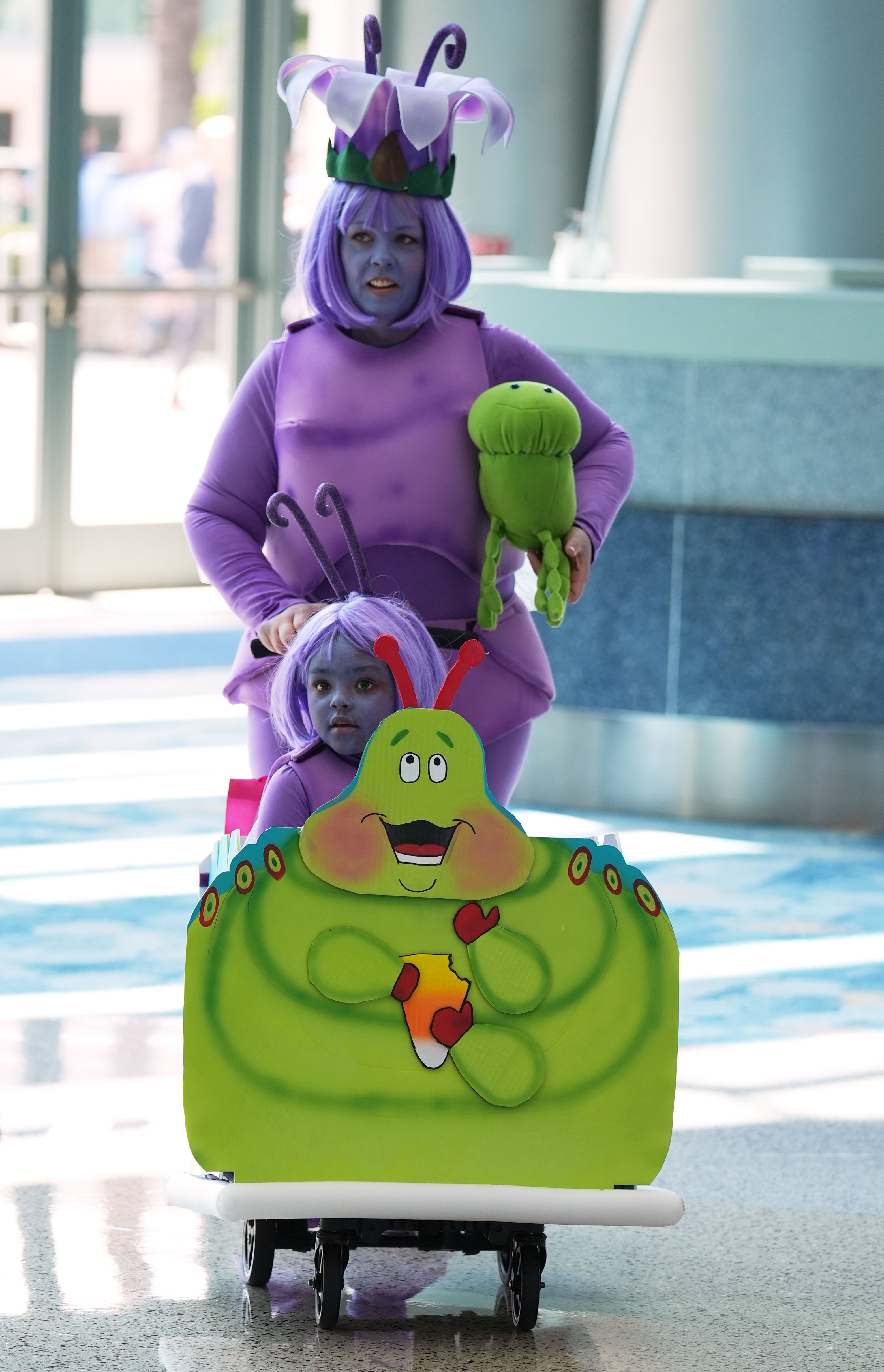 Casey Haddow of Moreno Valley, Calif., and her granddaughter Nyla Jackson, 5, dressed as "A Bug's Life" characters, attend D23 on Aug. 14, 2026 in Anaheim, Calif.