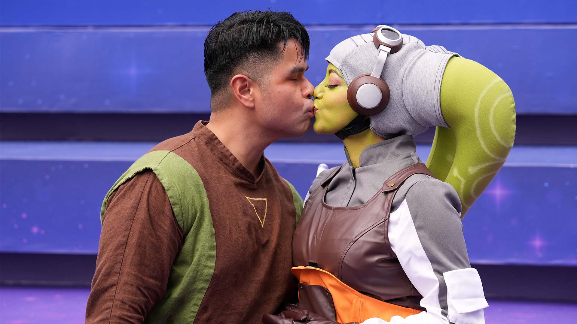 Geofrey Panlaque and Rina Ramos, both of Orlando, Fla. and dressed as characters from the "Star Wars Rebels" series, share a kiss at D23 in Anaheim, Calif. on Aug. 14, 2026.