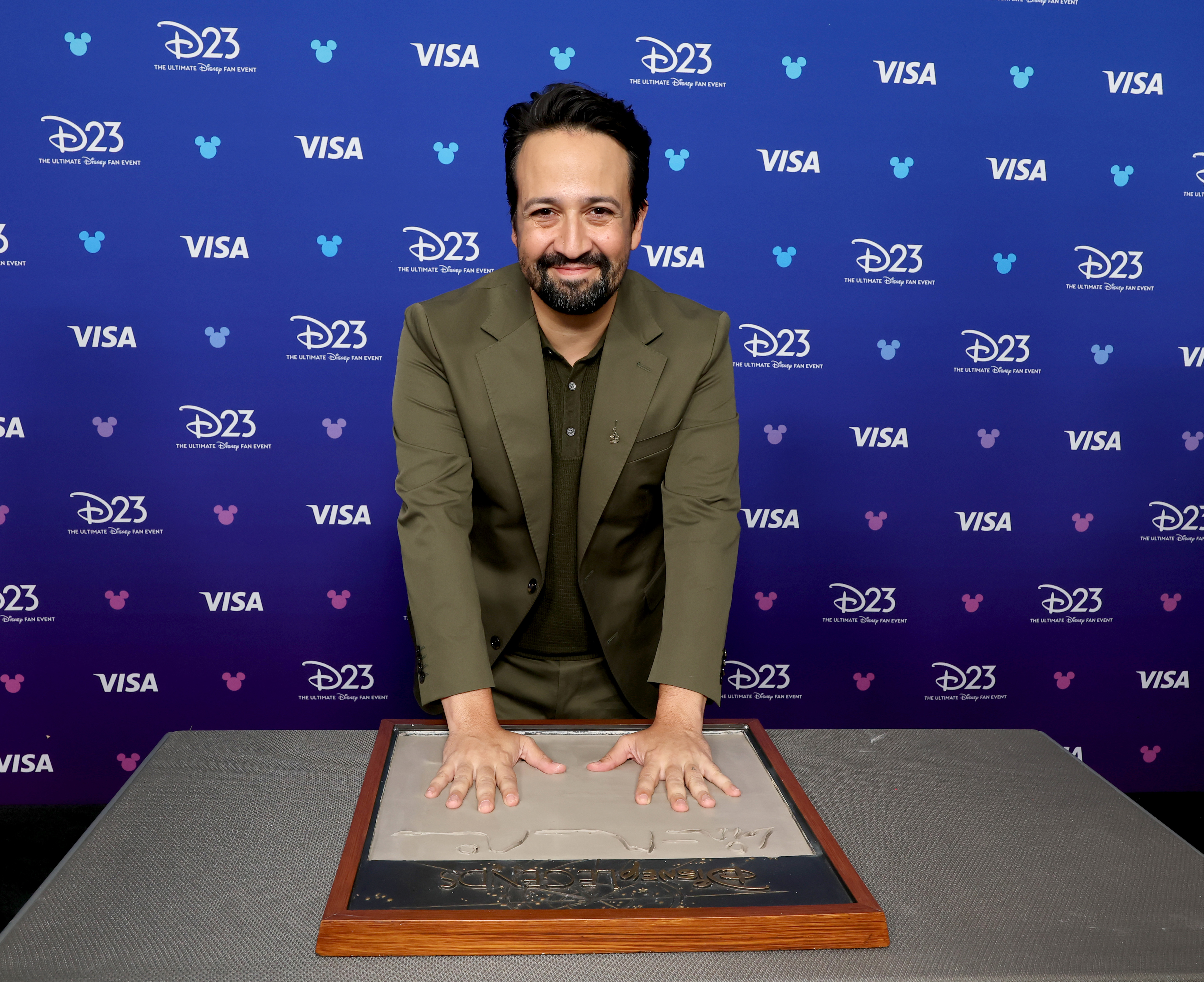 Lin-Manuel Miranda gets his handprints at the Disney Entertainment Showcase at D23: Legends on August 16, 2026 in Anaheim, California.
