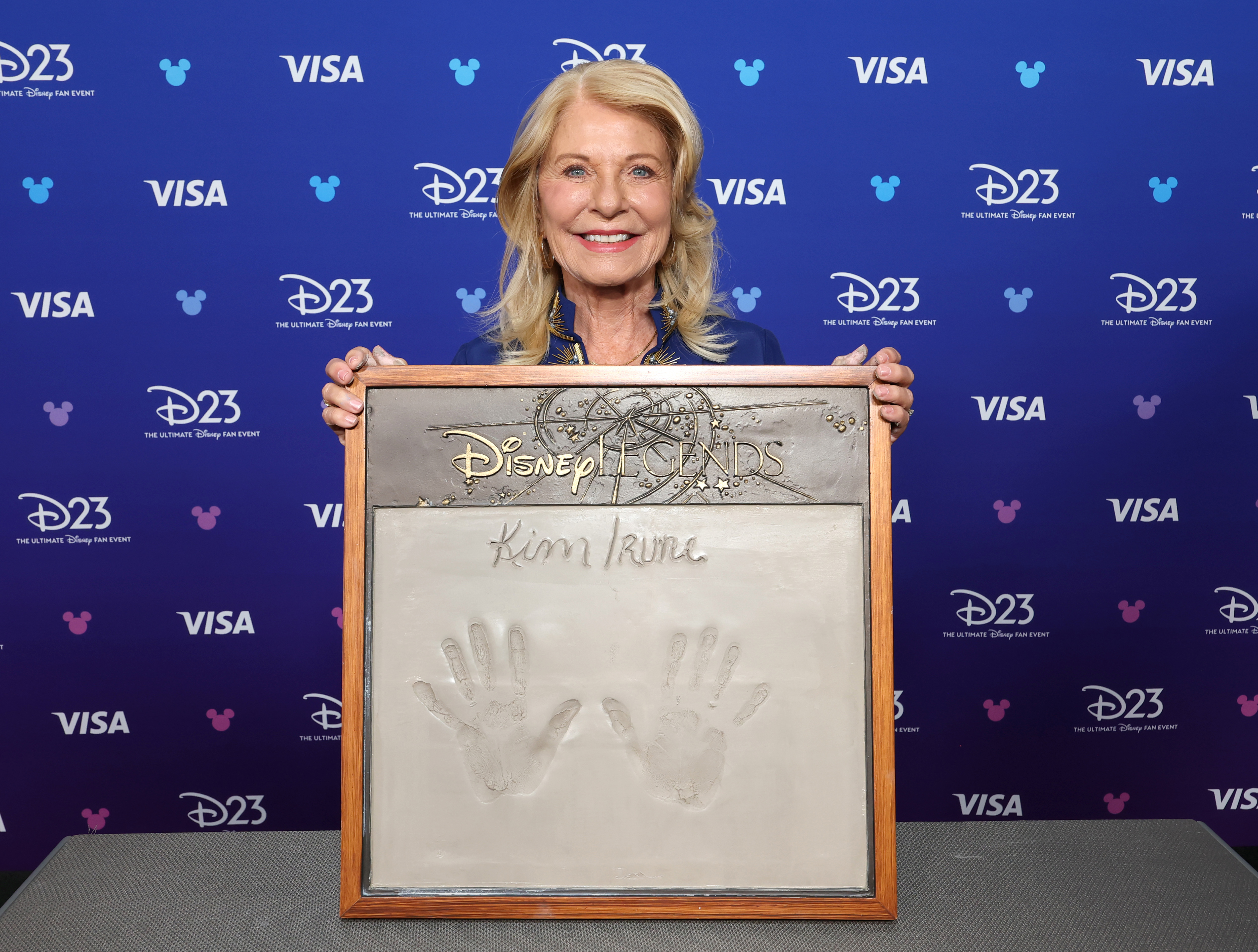 Kim Irvine gets her handprints done at D23 on August 16, 2026 in Anaheim, California.