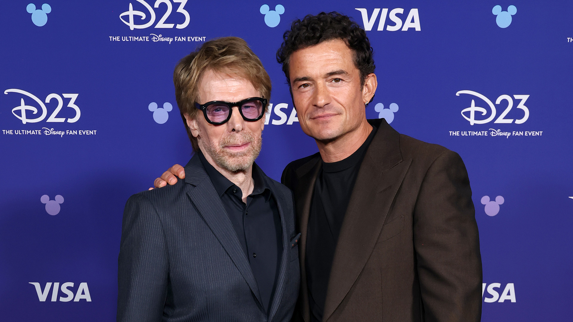 Disney Legend Jerry Bruckheimer and Orlando Bloom are seen at D23 on August 16, 2026 in Anaheim, California.