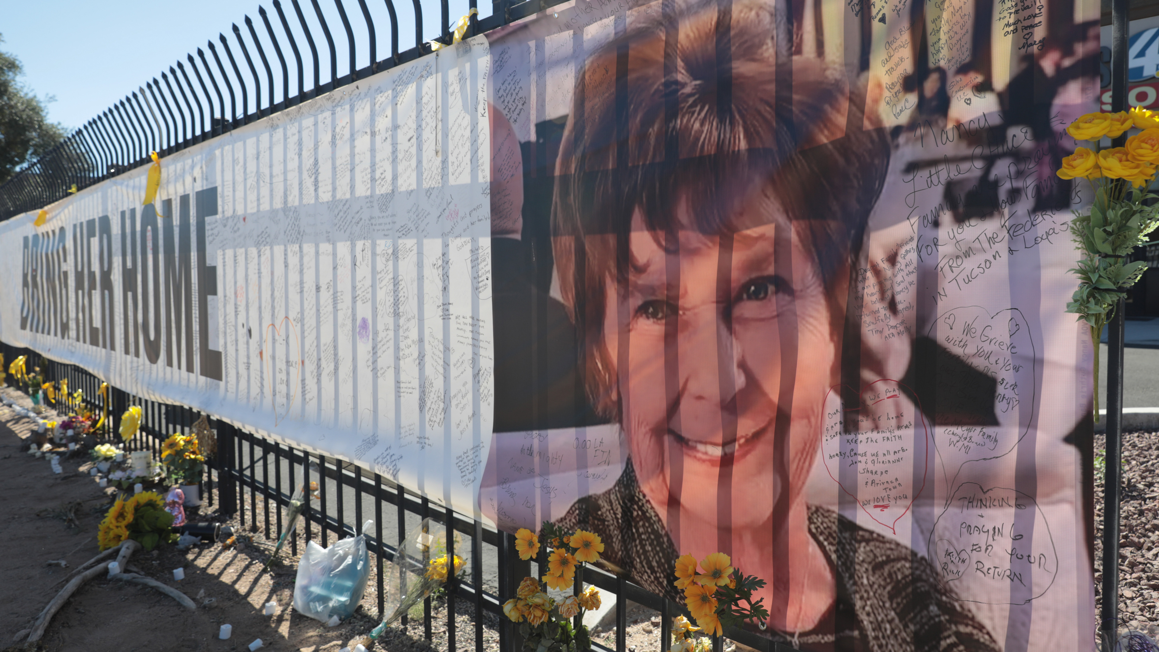 A banner reading "Bring Her Home" in support of Nancy Guthrie is displayed at KVOA in Tucson, Arizona on March 3, 2026. 