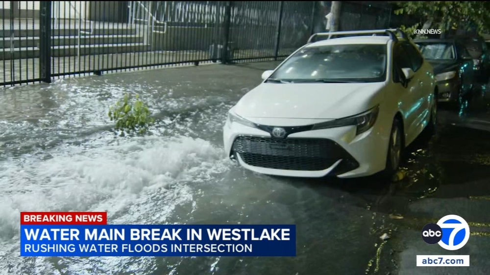 Rushing water floods Westlake intersection after water main break