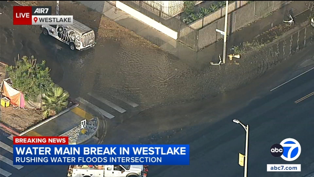Rushing water floods Westlake intersection after water main break