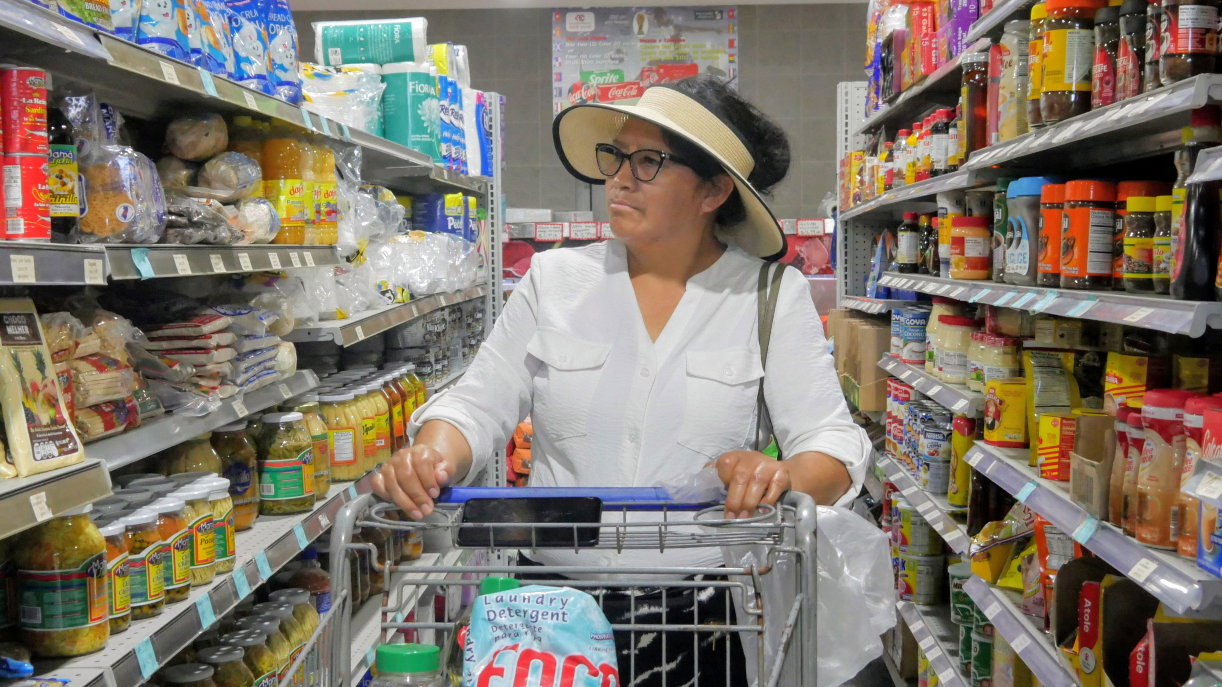Elizabeth Martínez pushes a shopping cart through a grocery store aisle on Thursday, July 2, 2026, in Cleveland, Texas. 