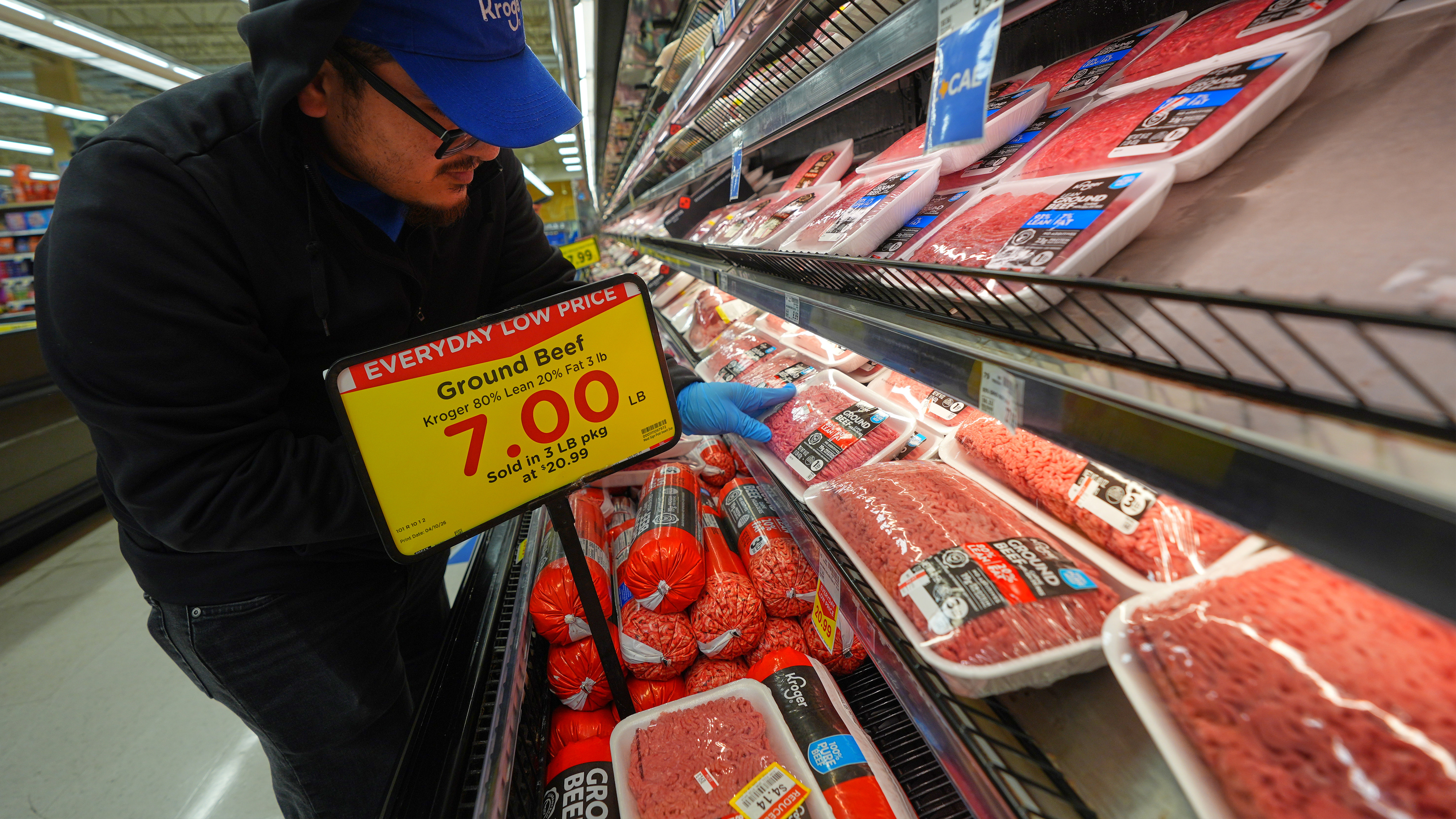 A grocery store worker places ground beef in the meat display in Dallas, Wednesday, April 15, 2026. 
