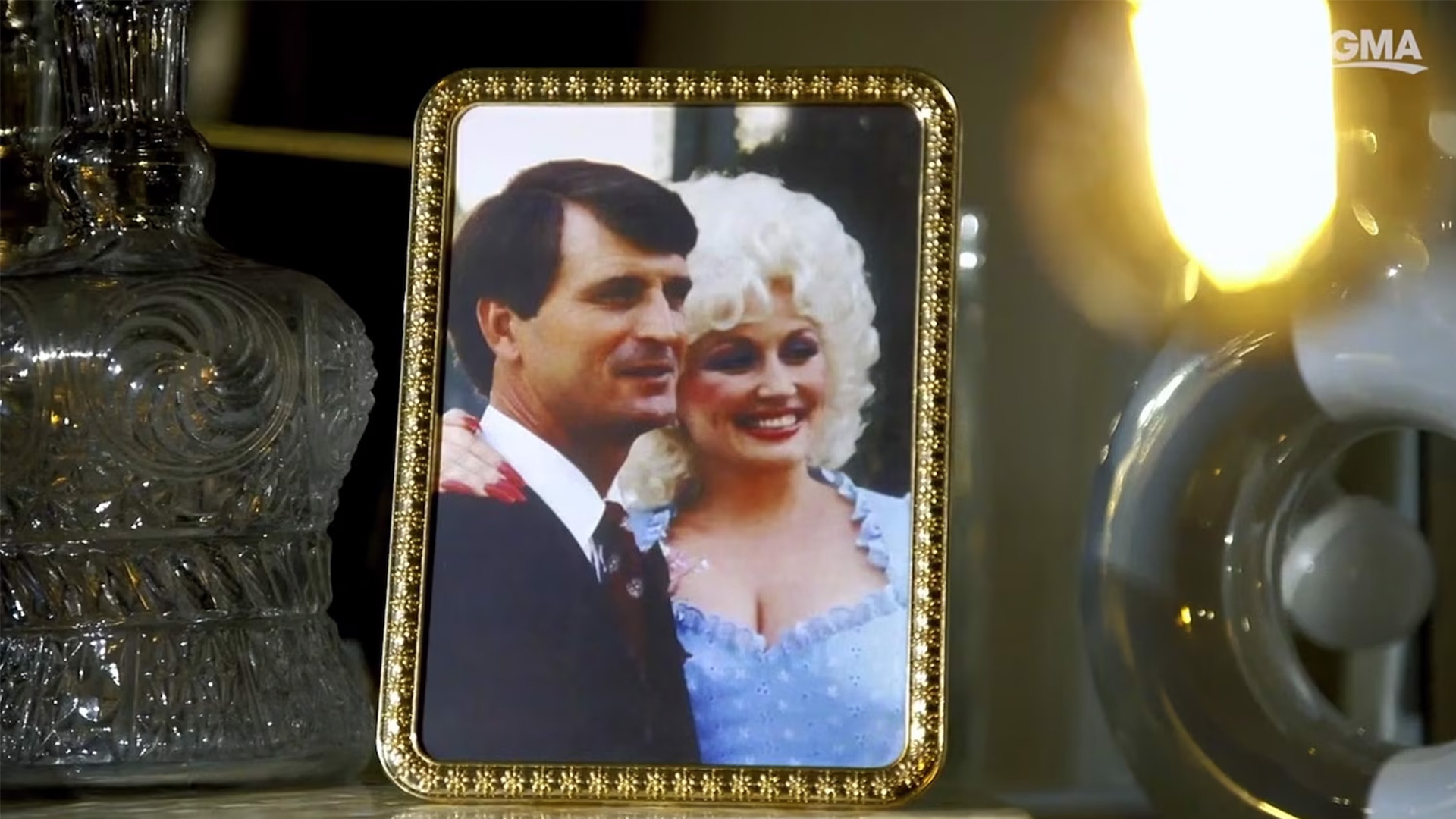 A framed photo of Dolly Parton and her husband Carl Dean stands on a table top while Parton was interviewed by ABC News in Nov. 2023.