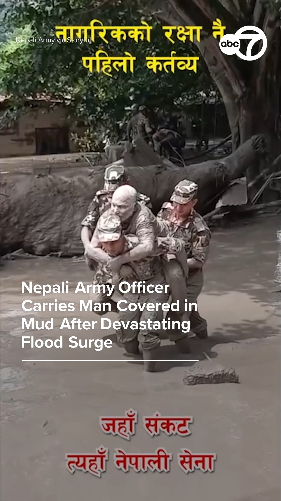 Nepali army officer carries man after devastating flood surge