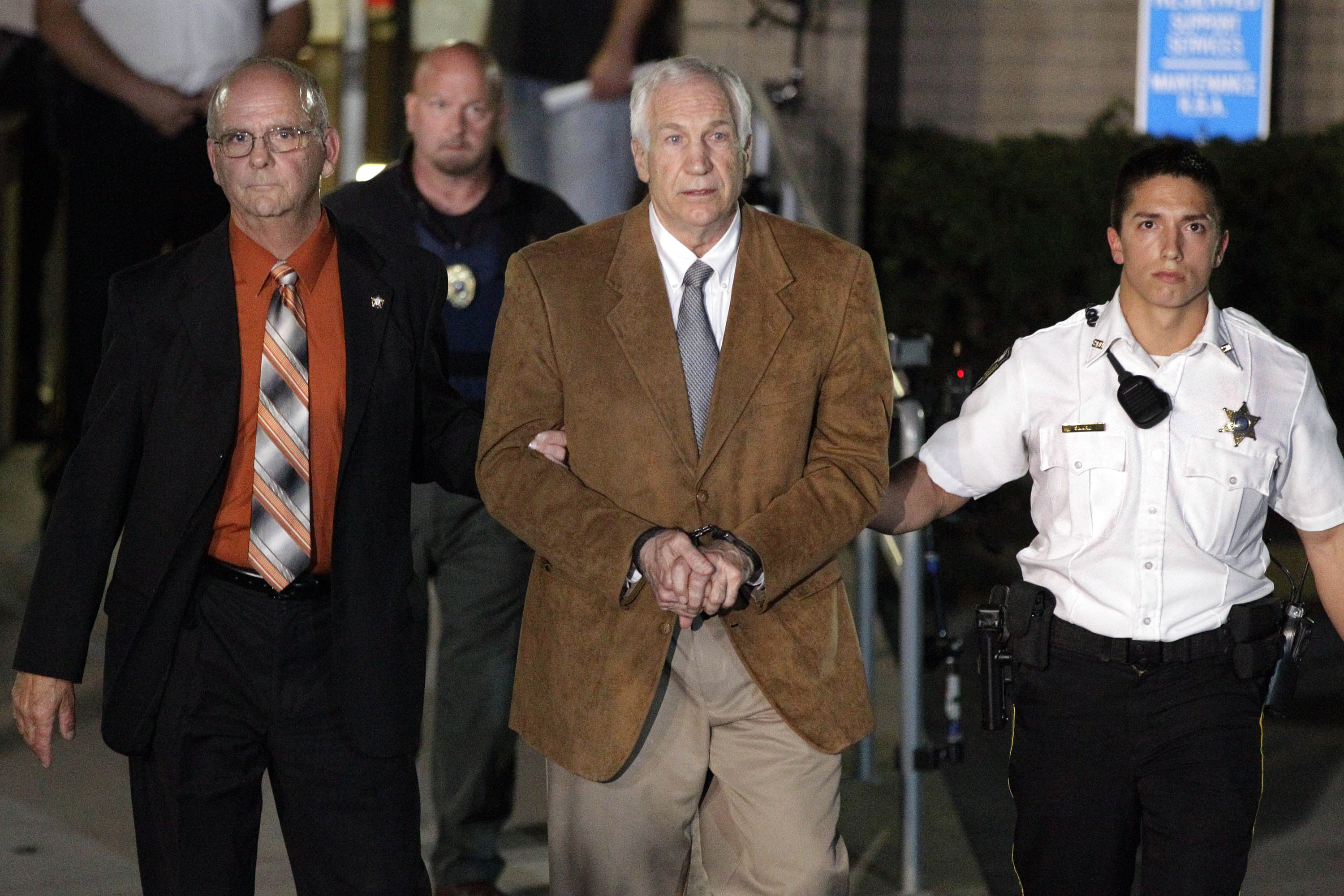 Jerry Sandusky leaves the Centre County Courthouse in custody with Sheriff Denny Nau after being found guilty of multiple charges of child sexual abuse on June 22, 2012