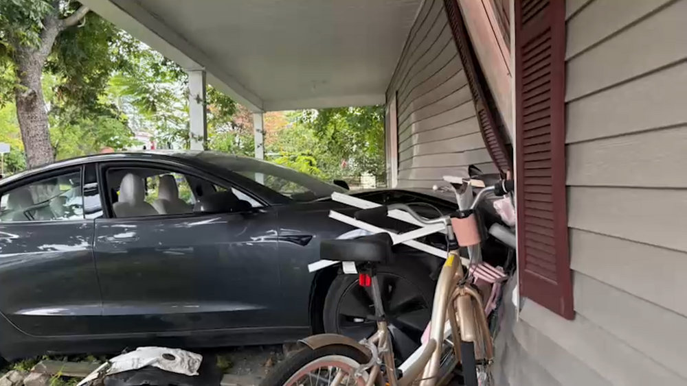 Tesla crashes through Chester home's living room, injuring resident