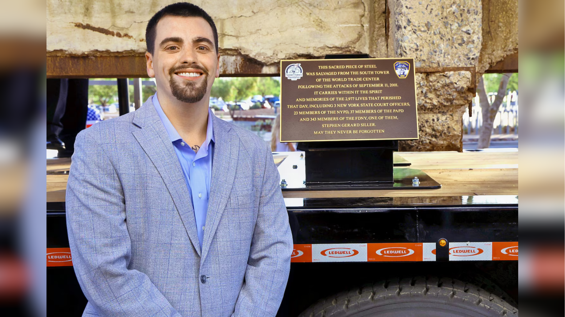 Stephen Siller Jr. poses with the steel beam from the World Trade Center during his Steel Across America tour.