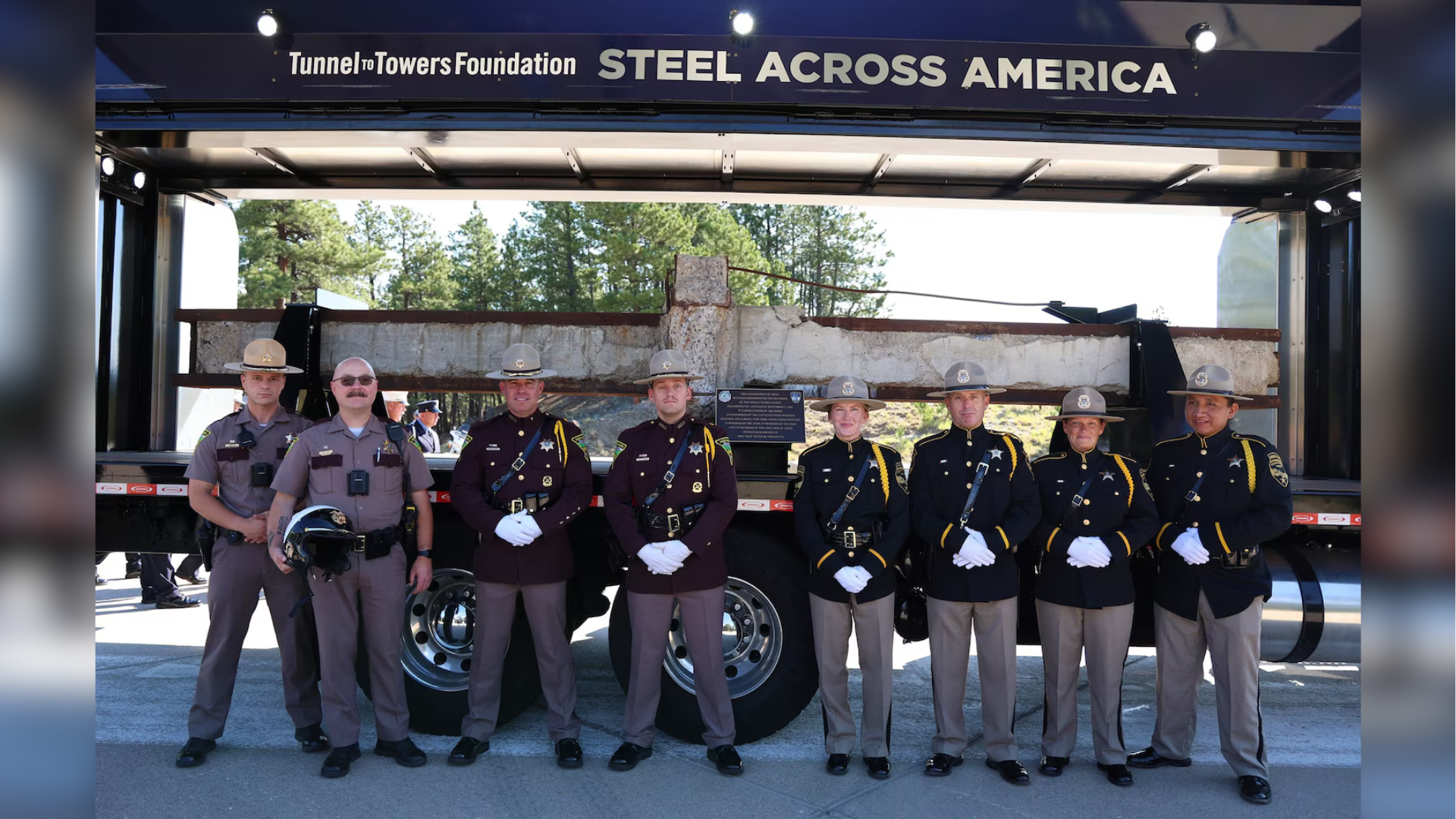 Law enforcement poses with a steel beam from the World Trade Center at Mount Rushmore in South Dakota, July 28, 2026.