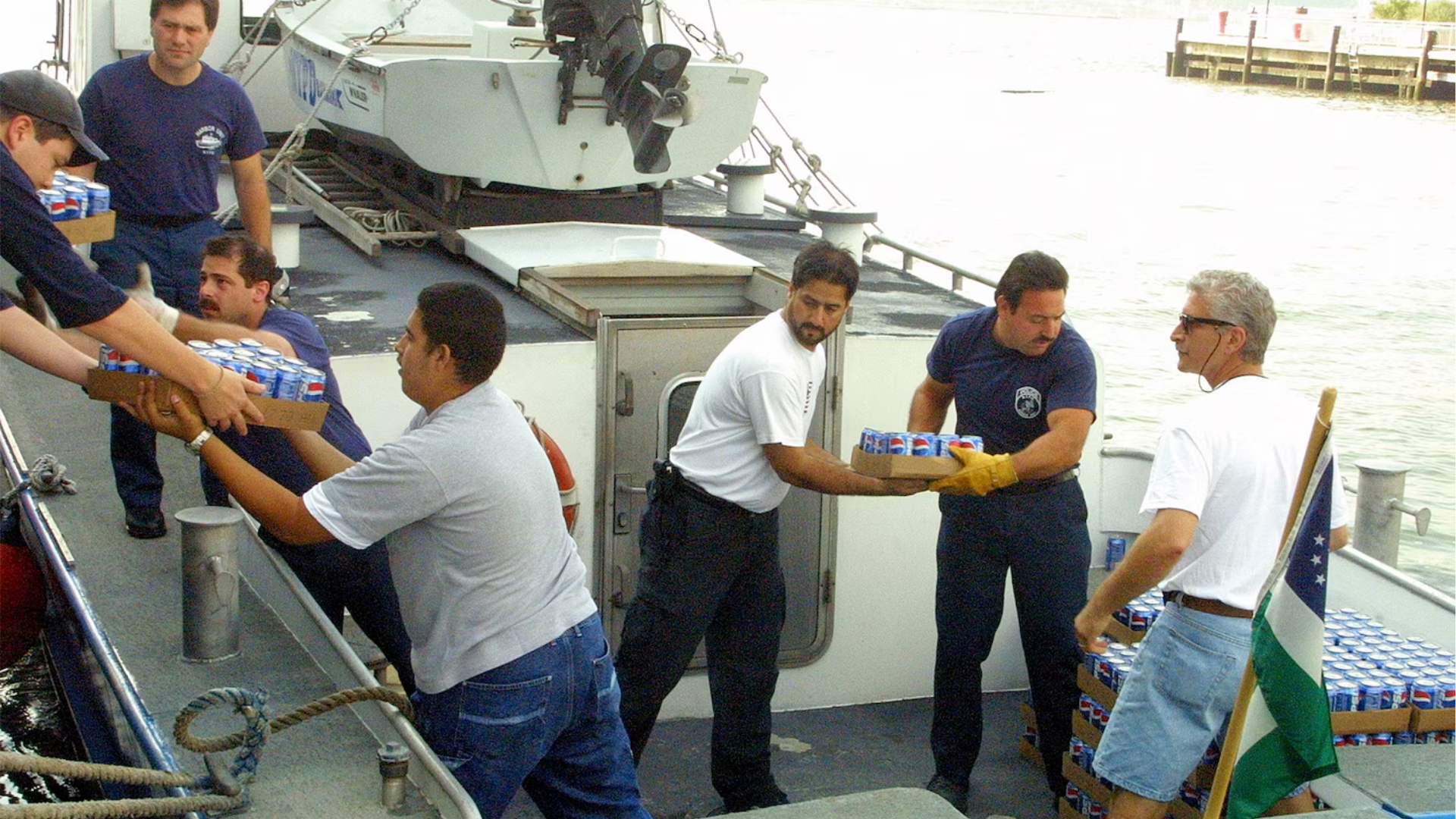 Chef Don Pintabona (center) helps load cans of soda onto a boat to be delivered to Ground Zero after the Sept. 11 attacks.